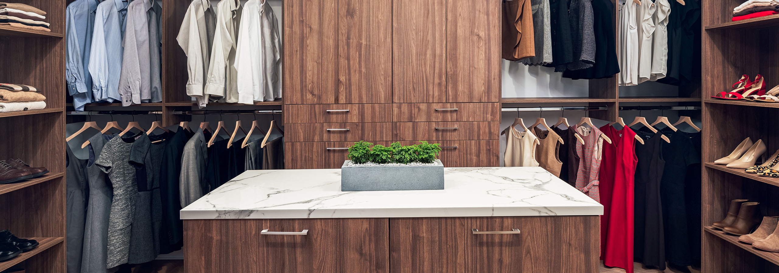AMLI Fountain Place penthouse closet with custom Italian dark brown island storage and built in cabinetry and hanging storage