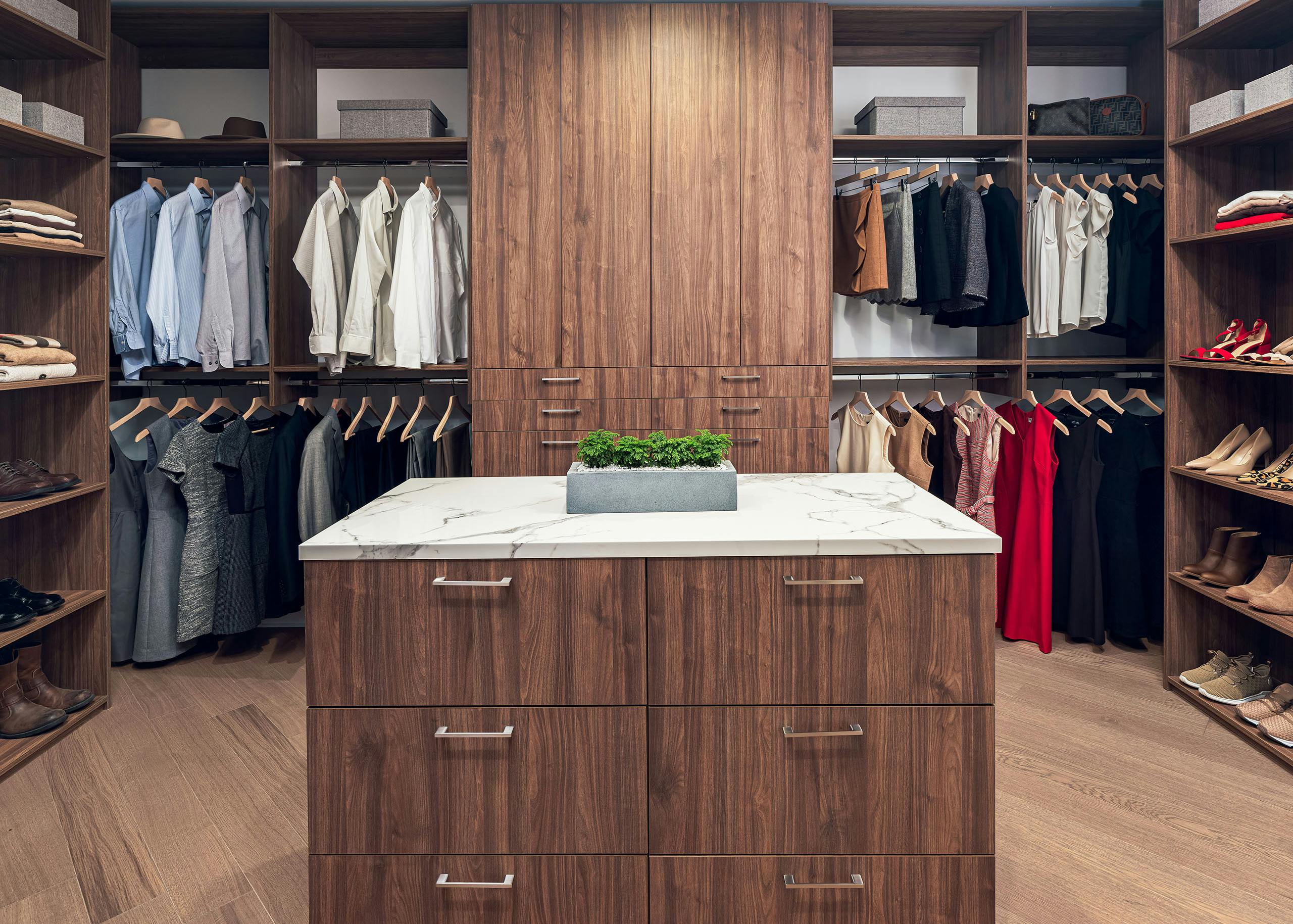 AMLI Fountain Place penthouse closet with custom Italian dark brown island storage and built in cabinetry and hanging storage
