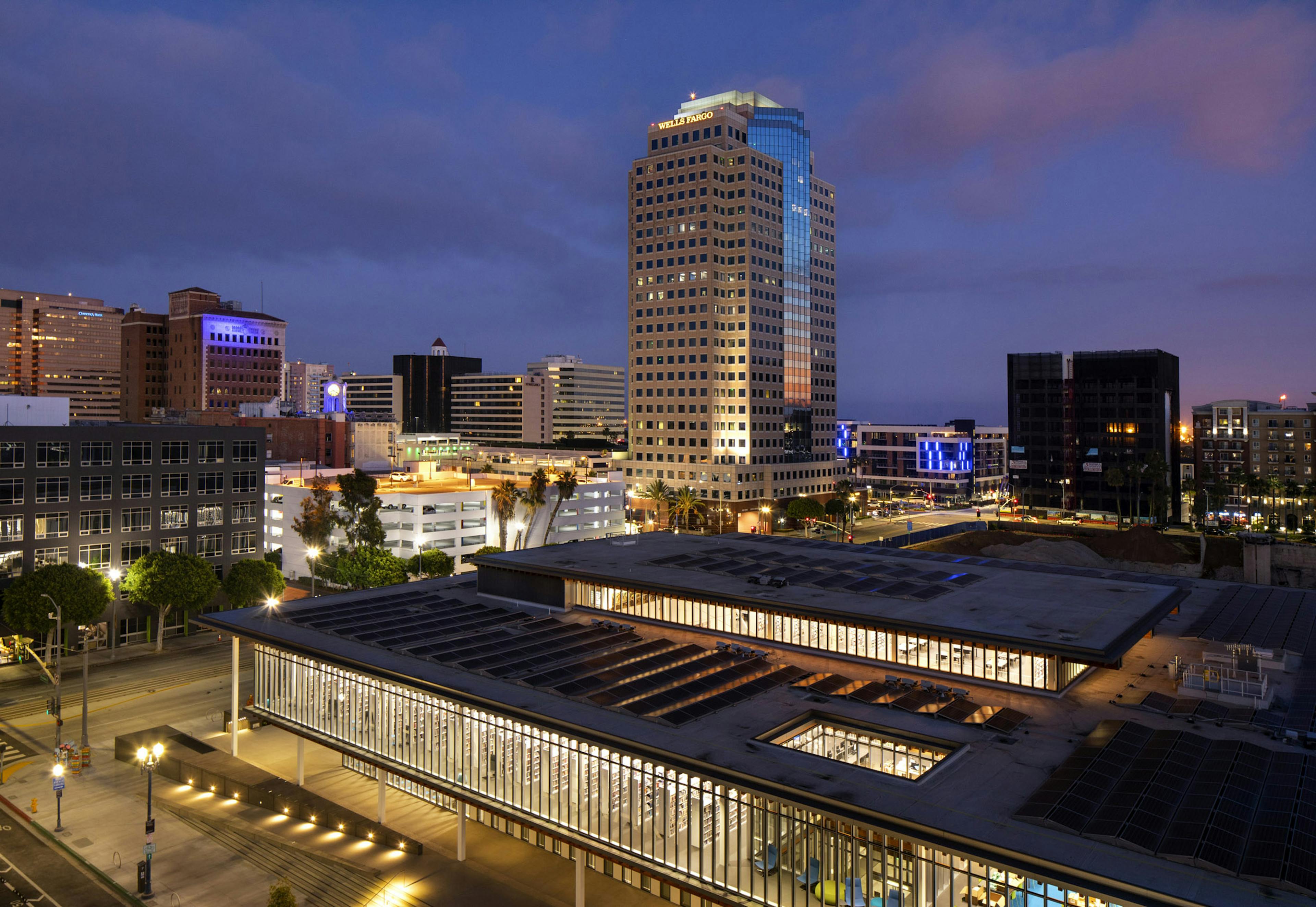 Aerial night view of the lit Billie Jean Library located directly across from AMLI Park Broadway apartment building