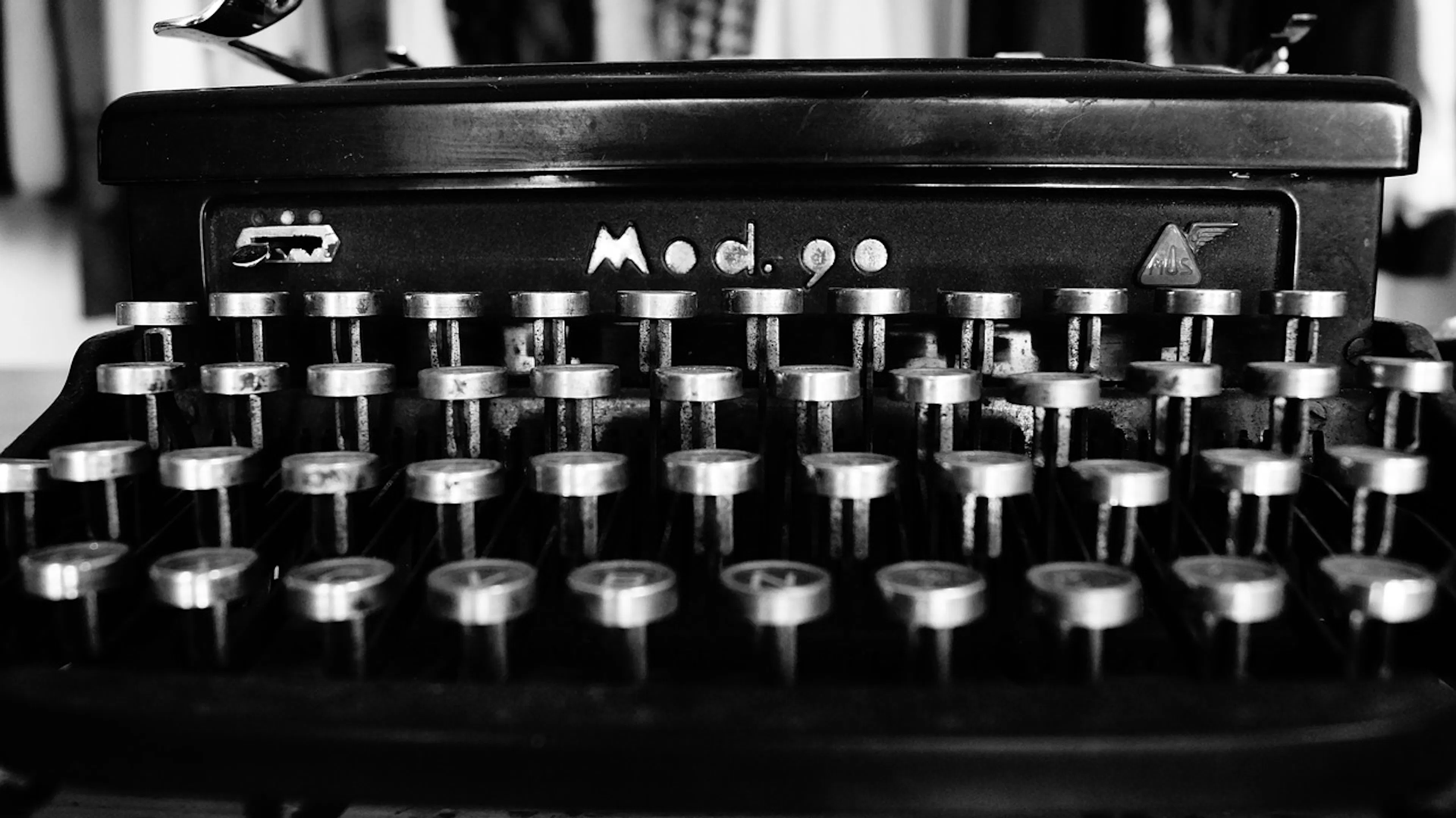 An old timey Model 90 typewriter photographed in black and white
