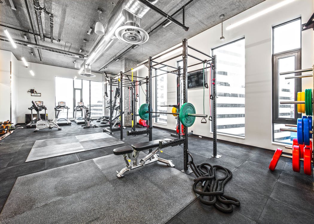 Interior Fitness Center of AMLI Arc with free standing weights squat racks with colorful weights and cardio equipment