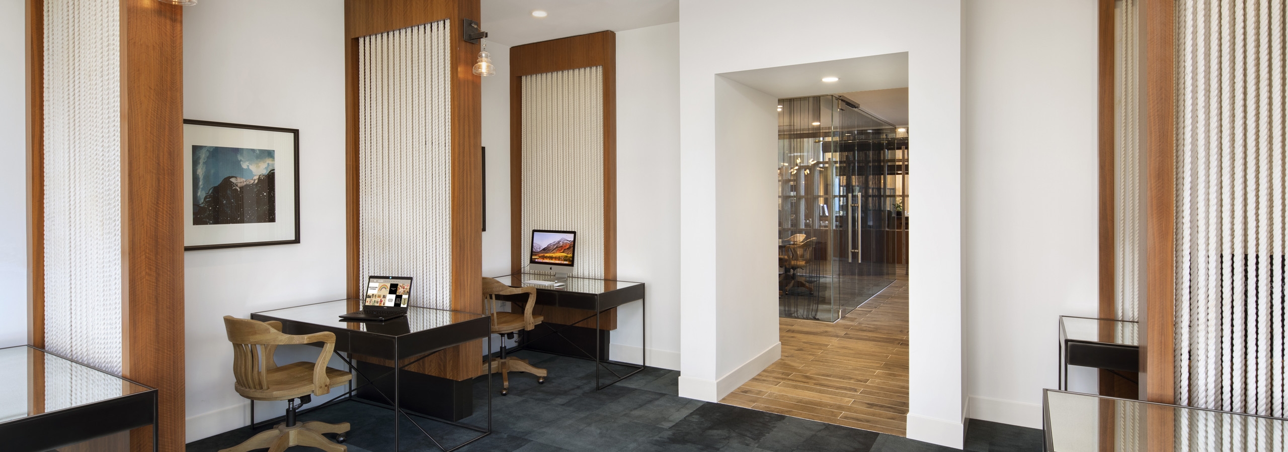 Interior daytime view of AMLI Marina De Rey apartment laptop lounge with individual work desks and unique rope style curtains