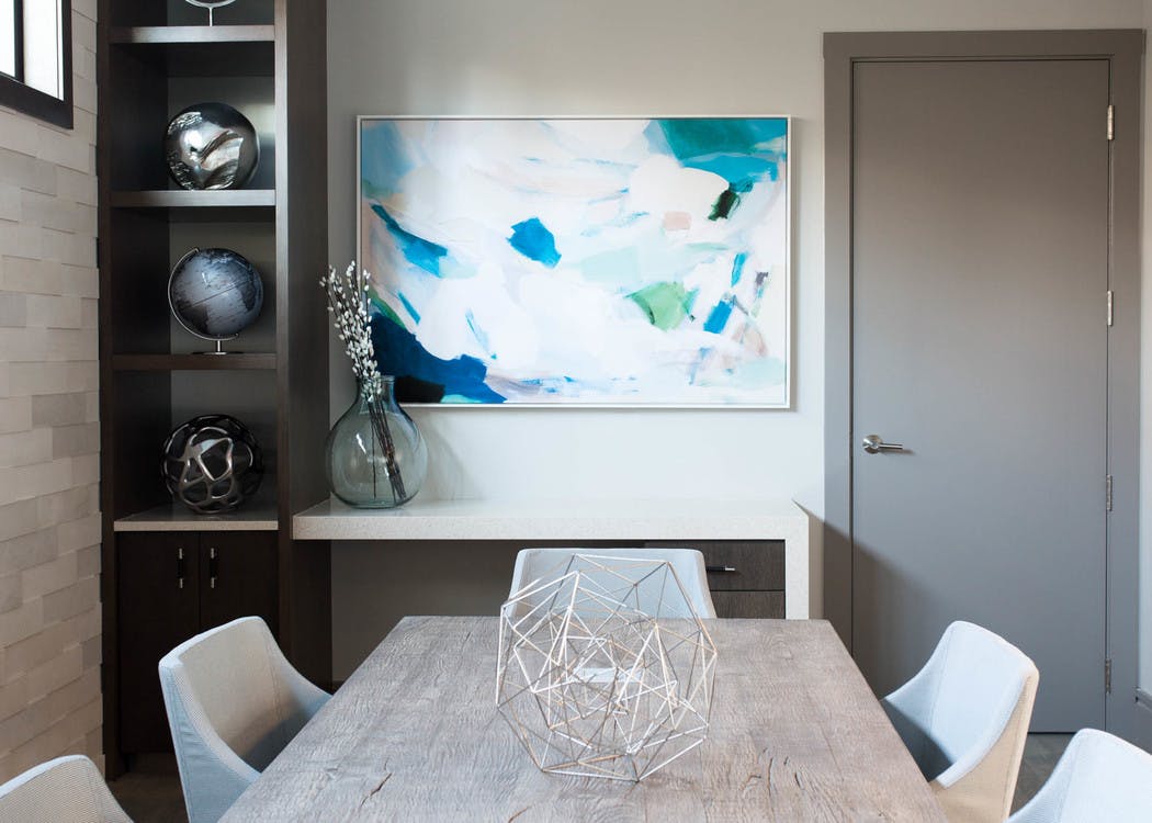 AMLI 3464 conference room with white chairs around a grey conference table with a dark wood shelf in the background
