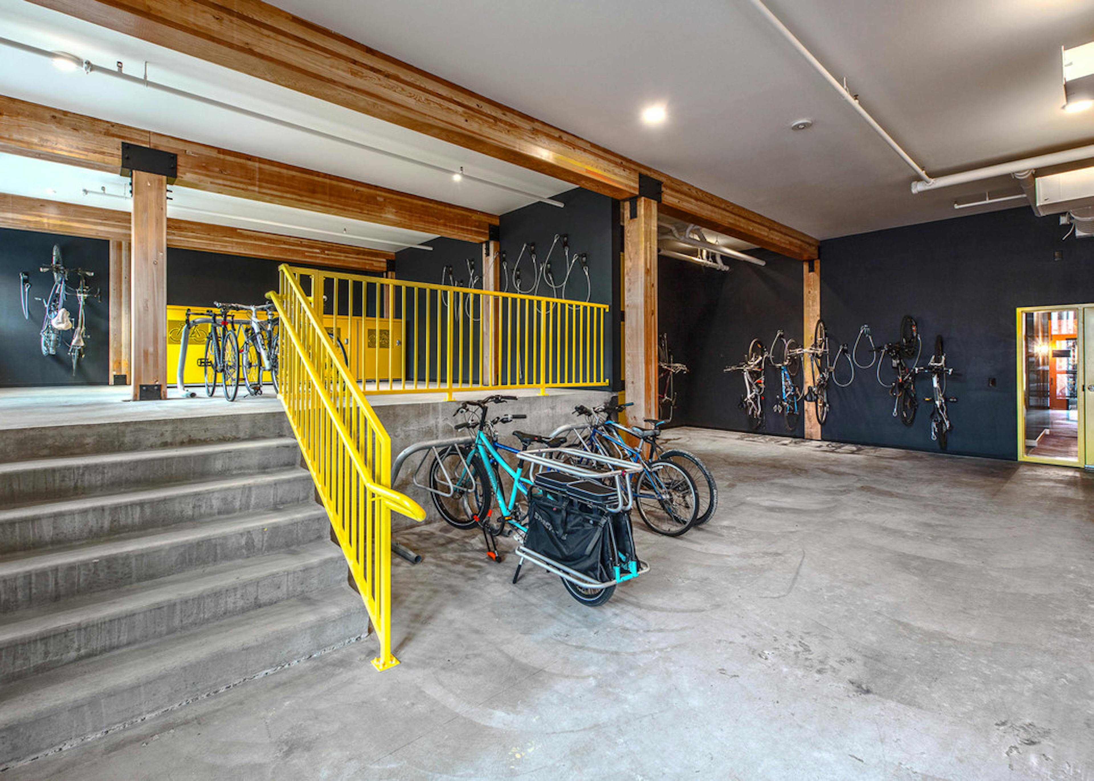 Interior bike room of AMLI Wallingford with bike storage tools storage lockers with large floor to ceiling windows facing the sidewalk  