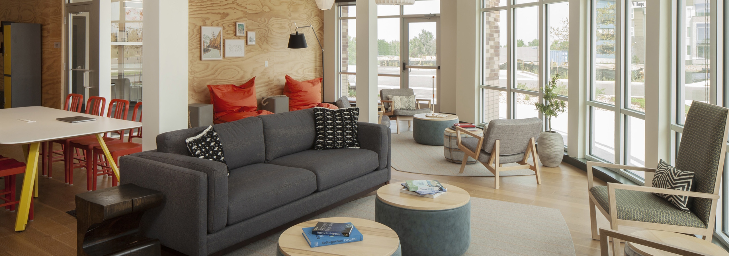 Interior view of AMLI Littleton Village cyber café with floor to ceiling windows and hardwood floors and several seating areas