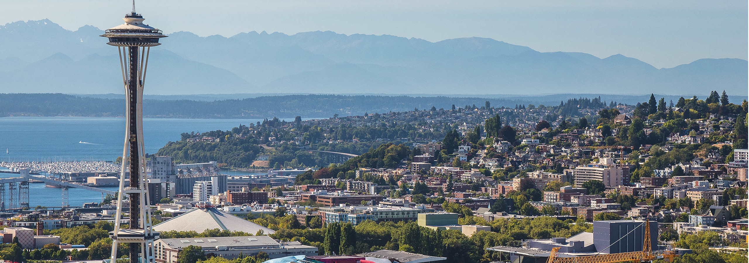 Beautiful Sunny Seattle day exterior view from AMLI Arc of the Seattle Space Needle and the Puget Sound and Queen Ann