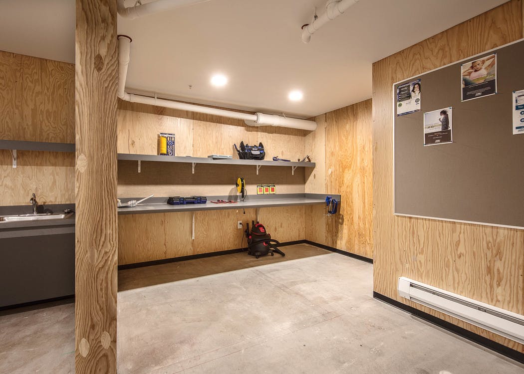 Interior view of the workshop for home projects and DIY space with hand tools and workspace at AMLI Wallingford