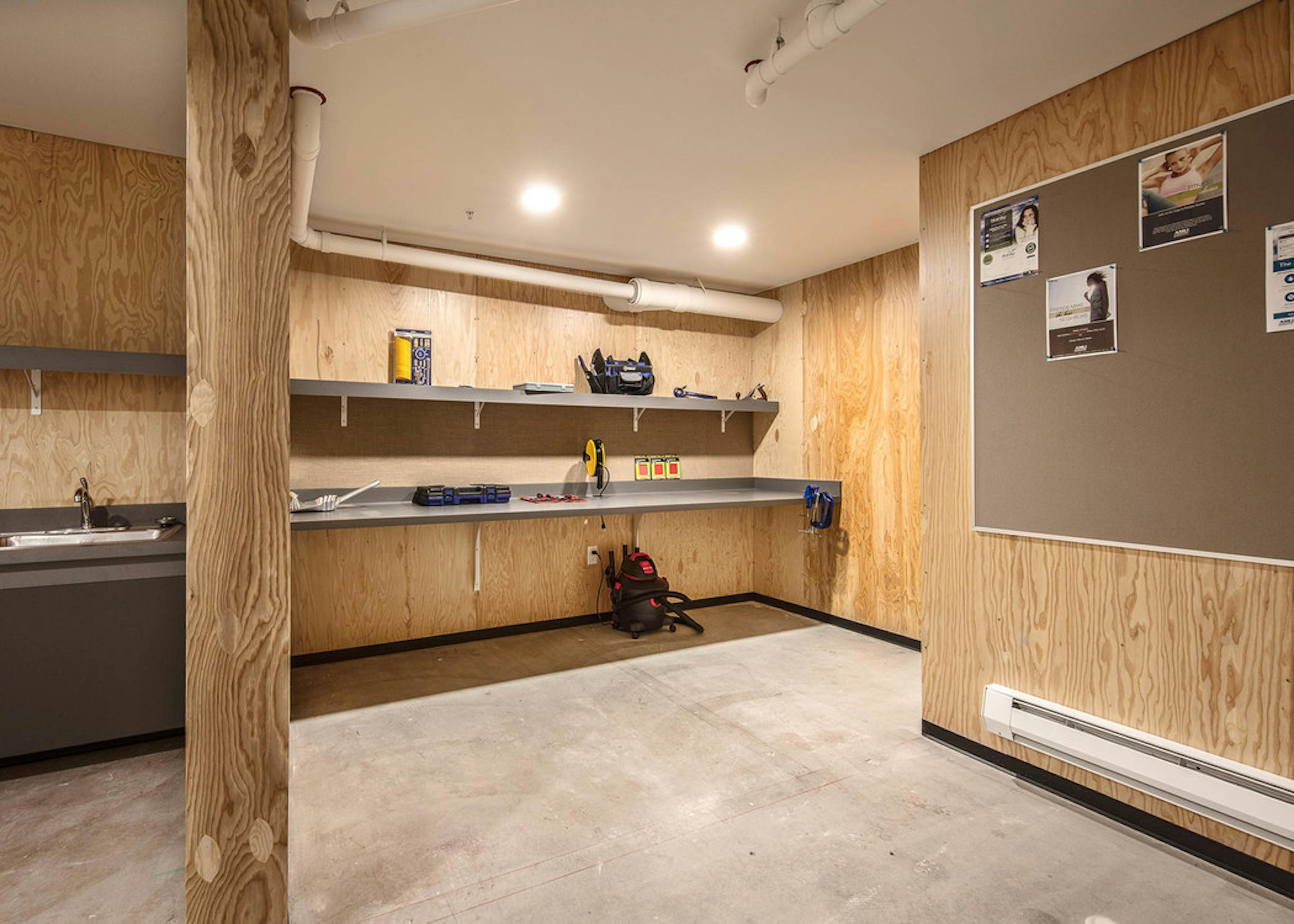 Interior view of the workshop for home projects and DIY space with hand tools and workspace at AMLI Wallingford 