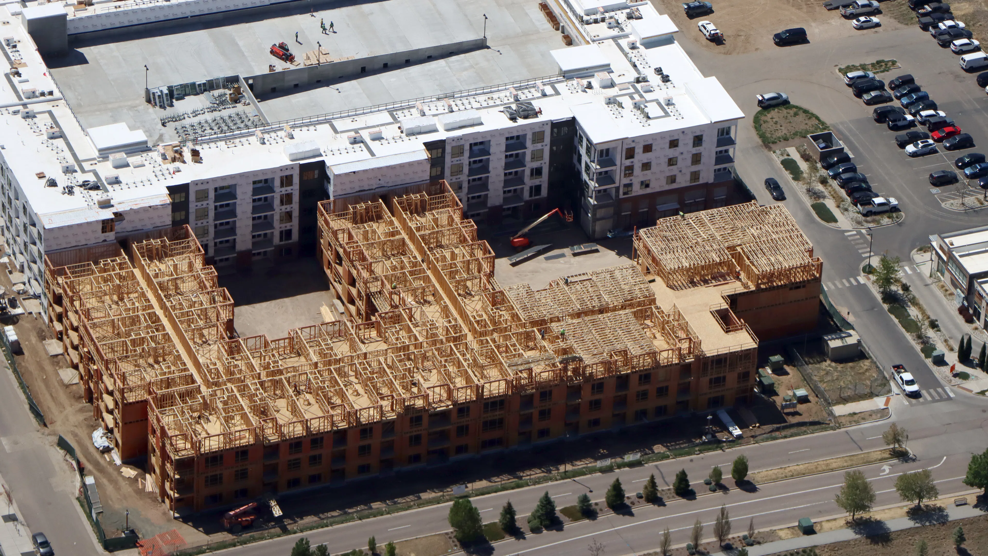 Aerial view of AMLI Village Park apartment community with the 2nd building's 4th floor framing complete.