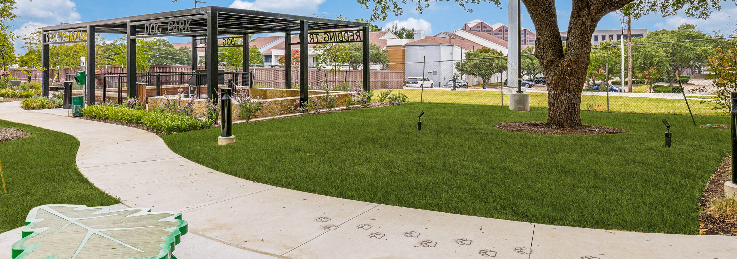 Open green space, covered pavilion, walking trail, decorative bench, and landscaped grounds at AMLI Treehouse.