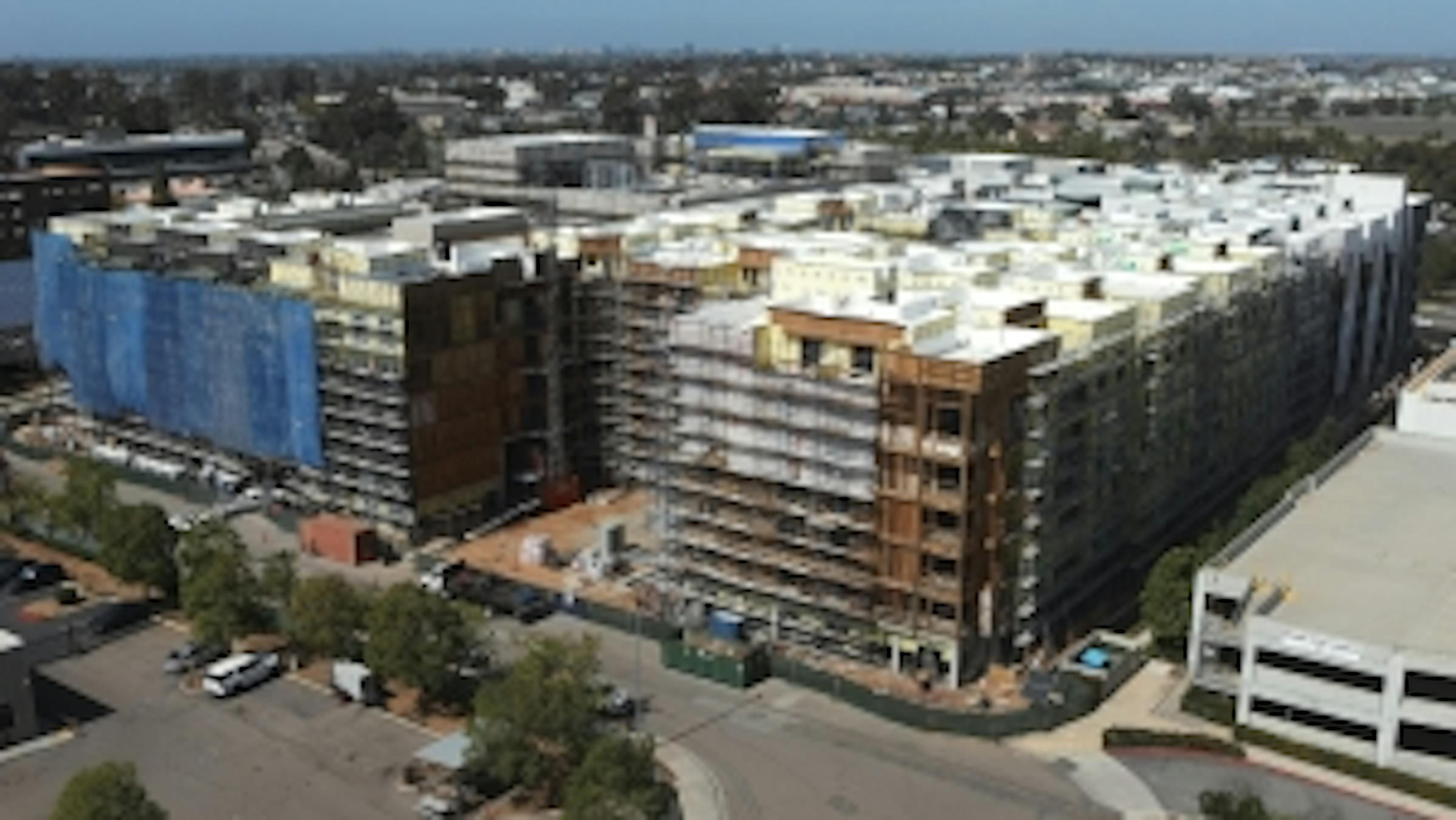 Aerial view of AMLI Aero apartments construction winding down with scaffolding being removed and signage added