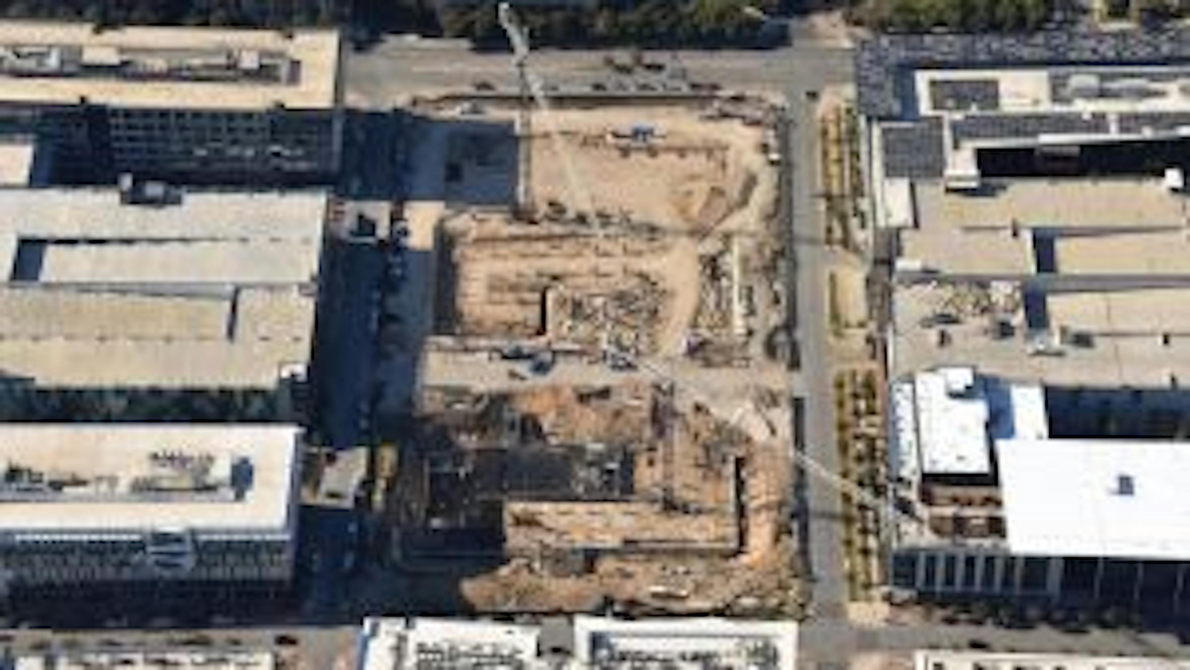 Aerial view of AMLI Park Central construction site with cranes and trucks and west building grade beams