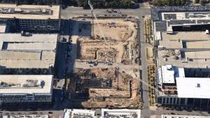 Aerial view of AMLI Park Central construction site with cranes and trucks and west building grade beams