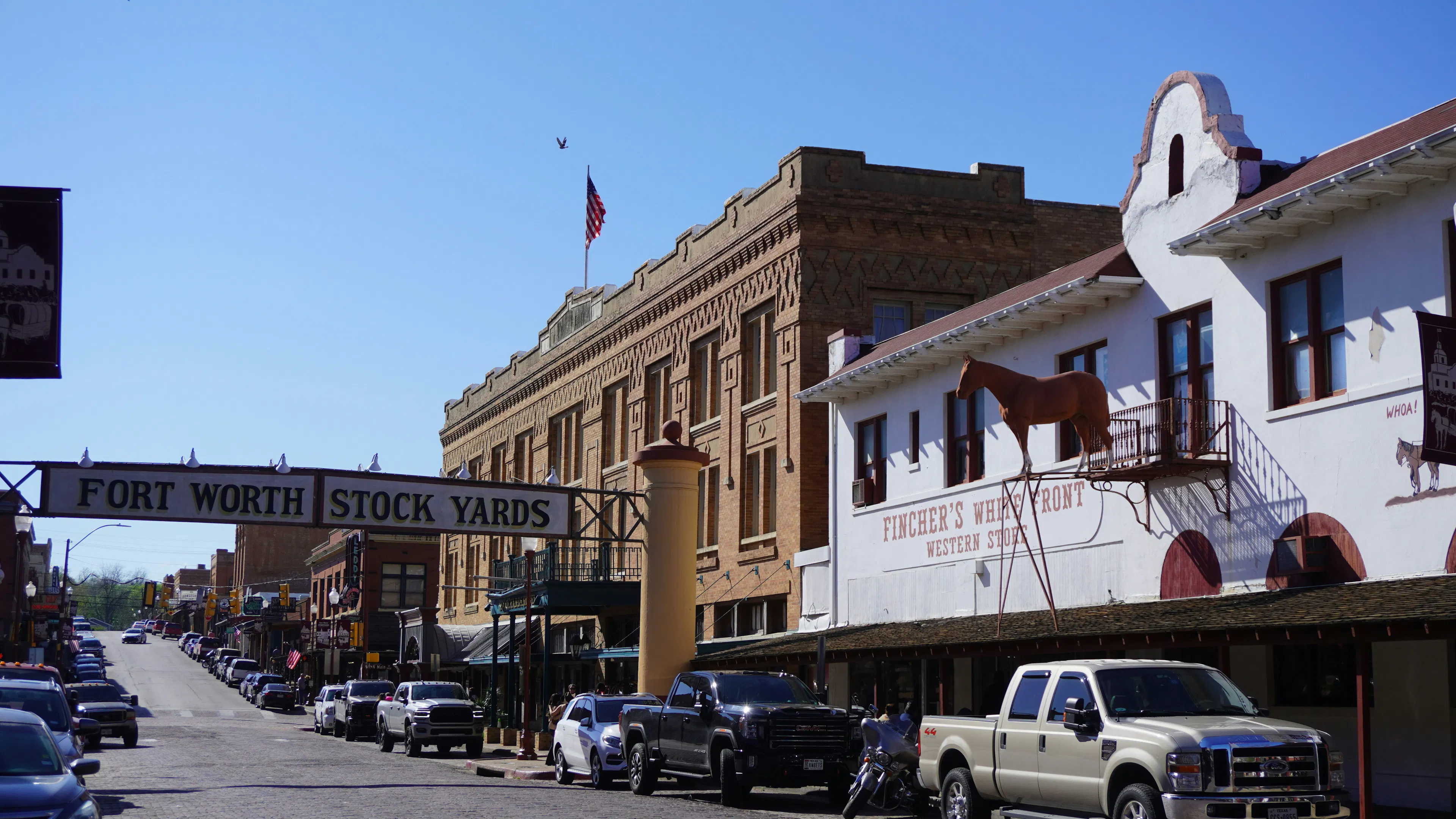 the famous Fort Worth Stockyards sign over a street lined with cards
