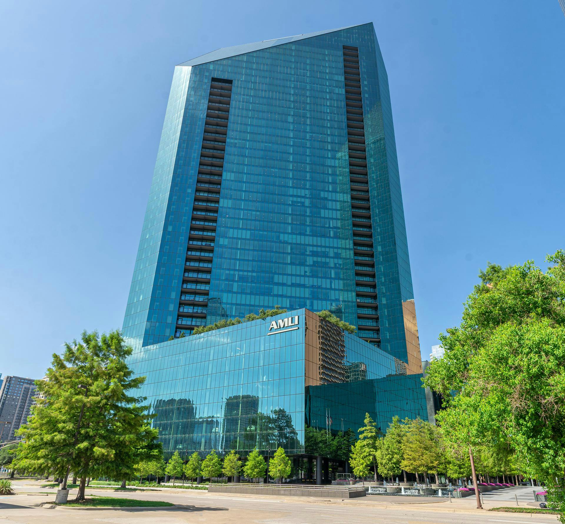 The exterior of AMLI Fountain Place in Dallas on a clear and sunny summer day