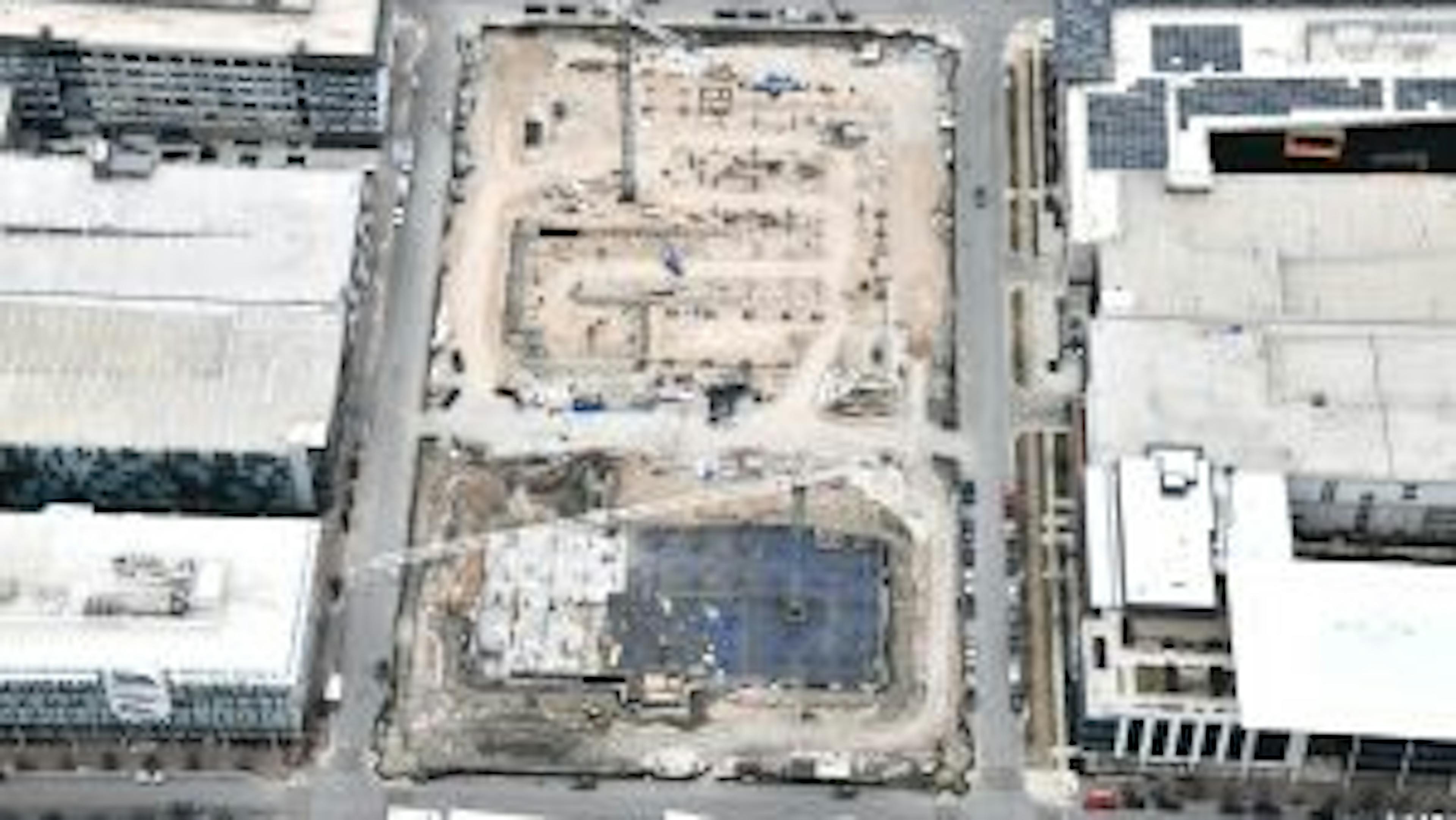 Aerial view of AMLI Park Central construction site with cranes and trucks and buildings having walls and columns poured