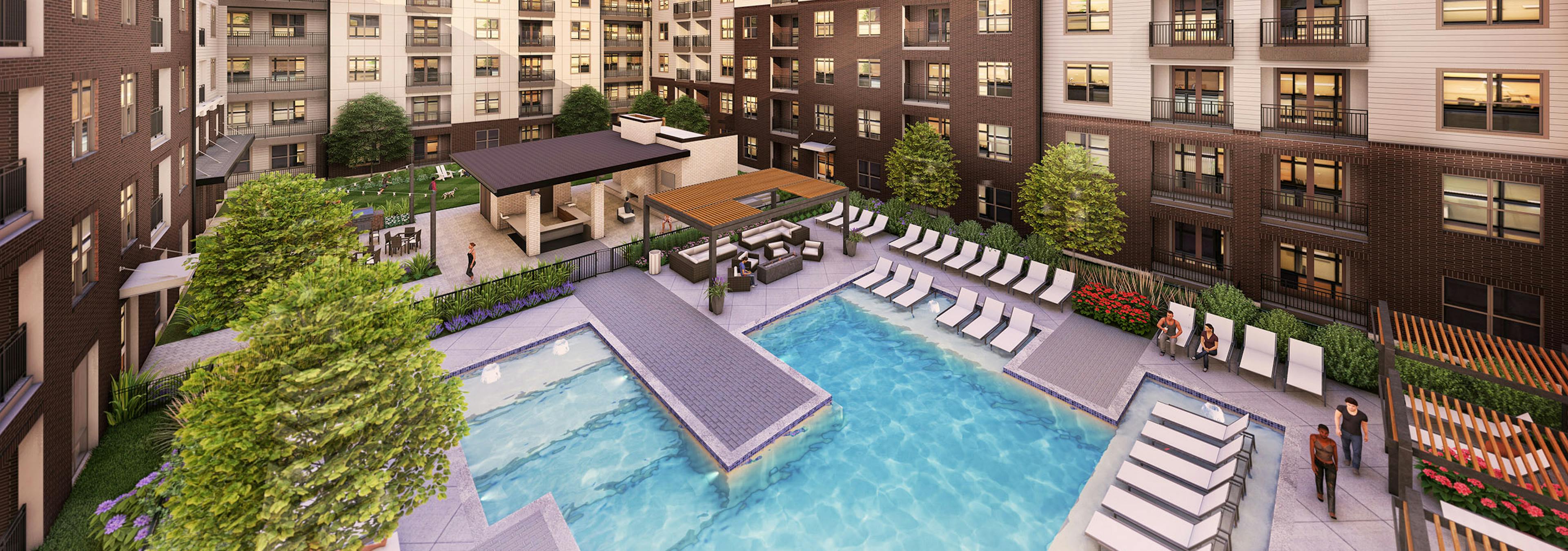 View of landscaped swimming pool at dusk with ample lounge seating nestled in the center of the community at AMLI North Park
