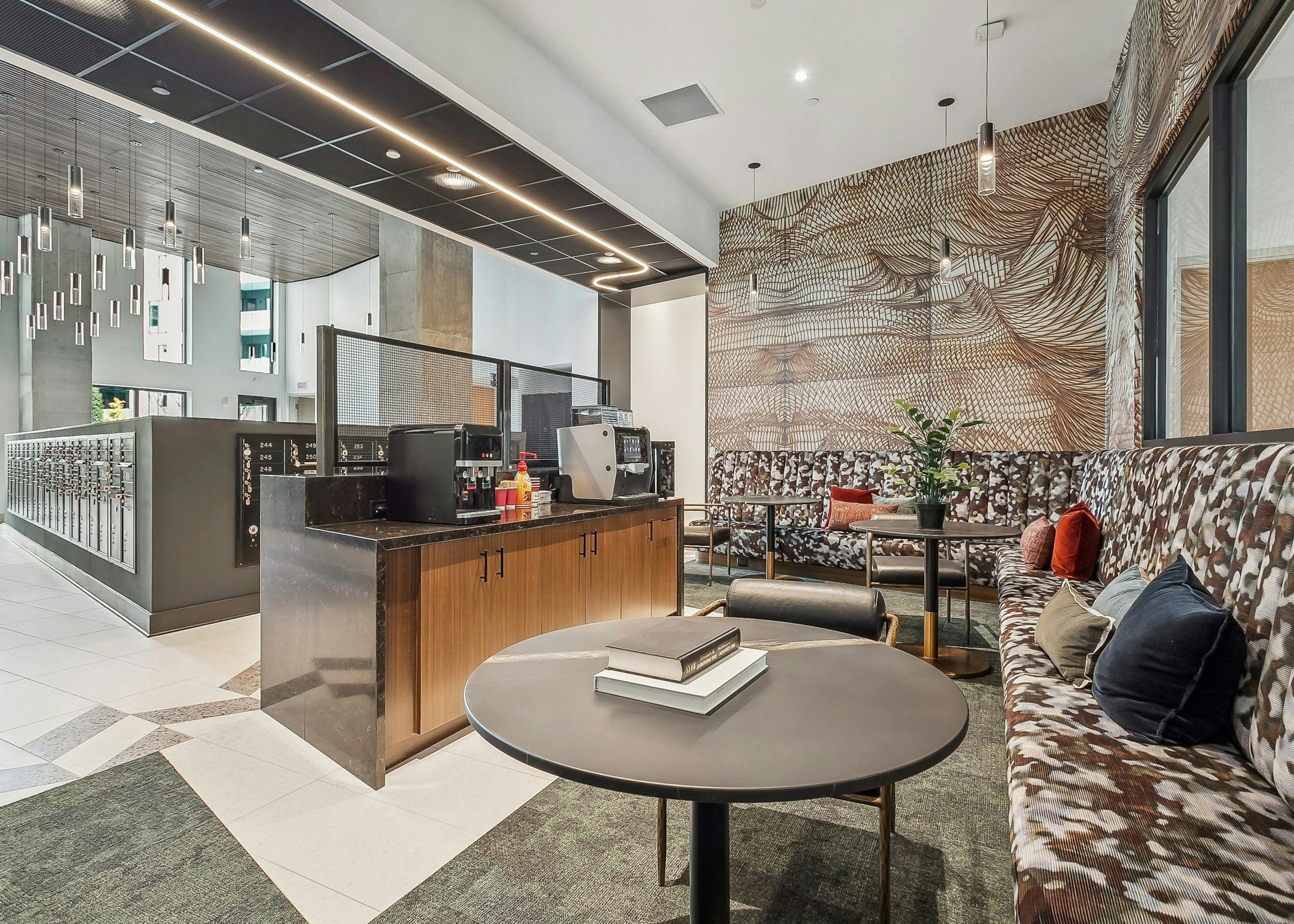 AMLI Atlantic Station mailroom lounge with patterned benches, round coffee tables and a coffee machine