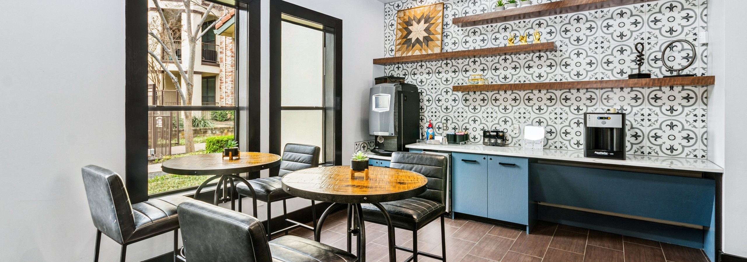 Java café for AMLI at Escena apartments with a colorful tile backsplash and leather bar stools surrounding wood high top tables