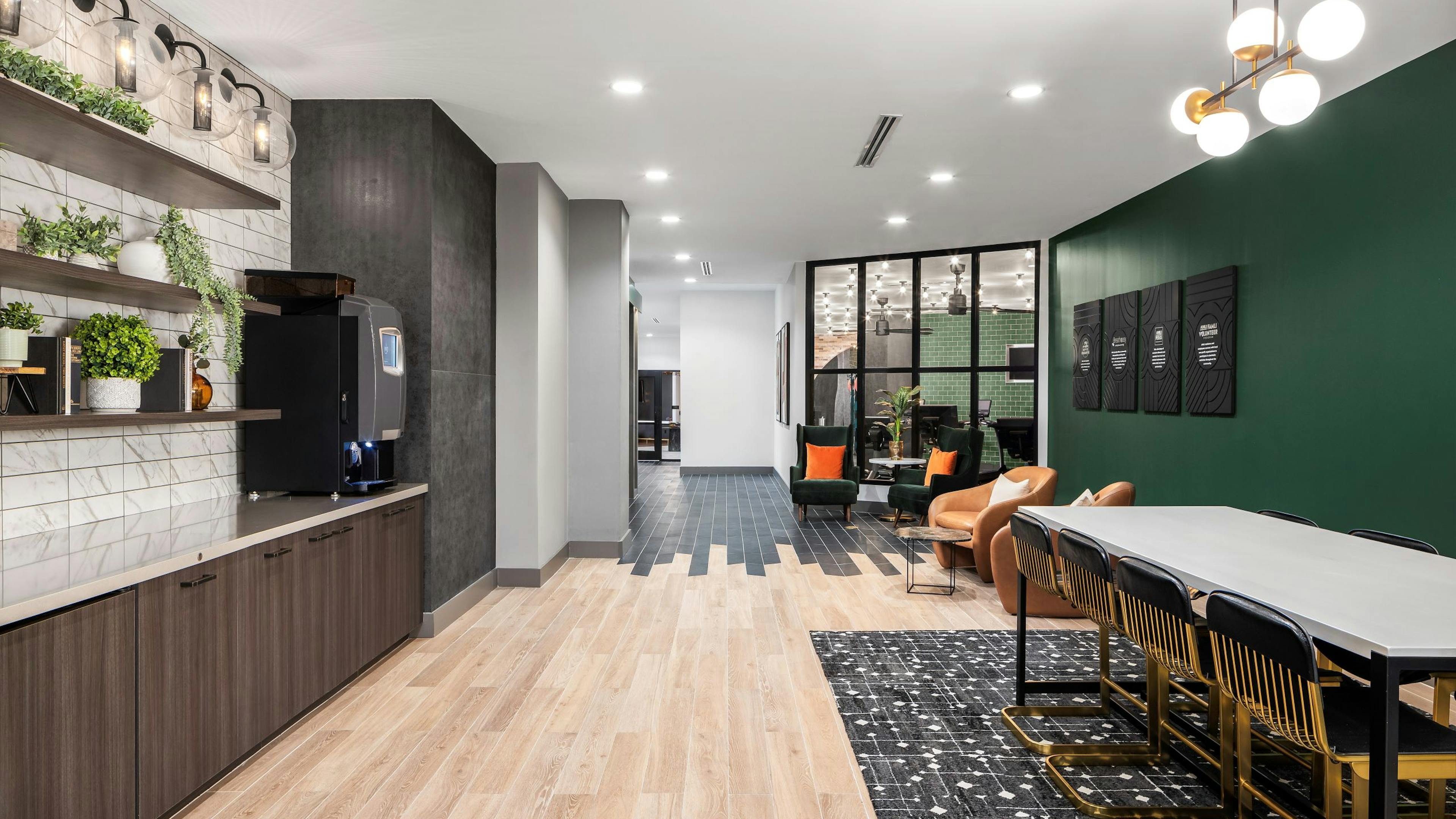 AMLI Flatiron cafe with brown shelves on white and gray tile wall over countertop across from various seating 