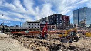 AMLI Golden Triangle dirt construction site  with diggers moving dirt and prepping the site for building apartments
