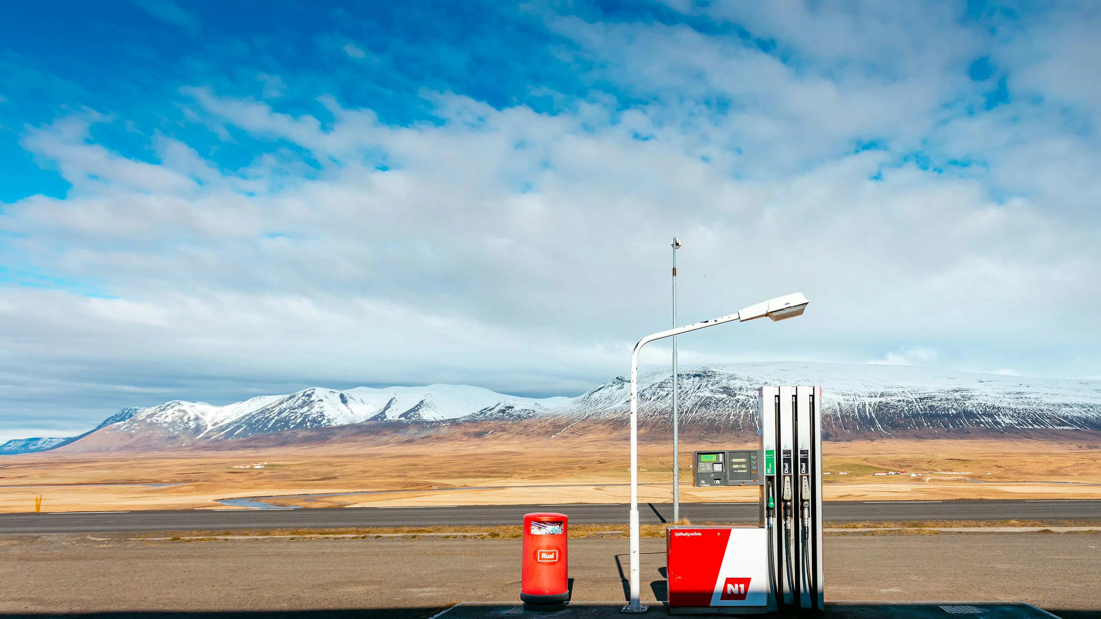 A single fuel pup in a remote valley with mountains rising up far in the background