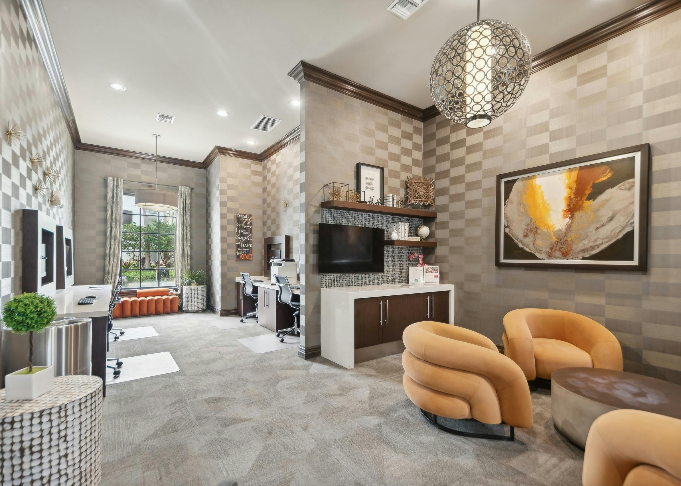 Business center at AMLI Toscana Place apartments with computer stations and printer and seating area with gold comfy chairs