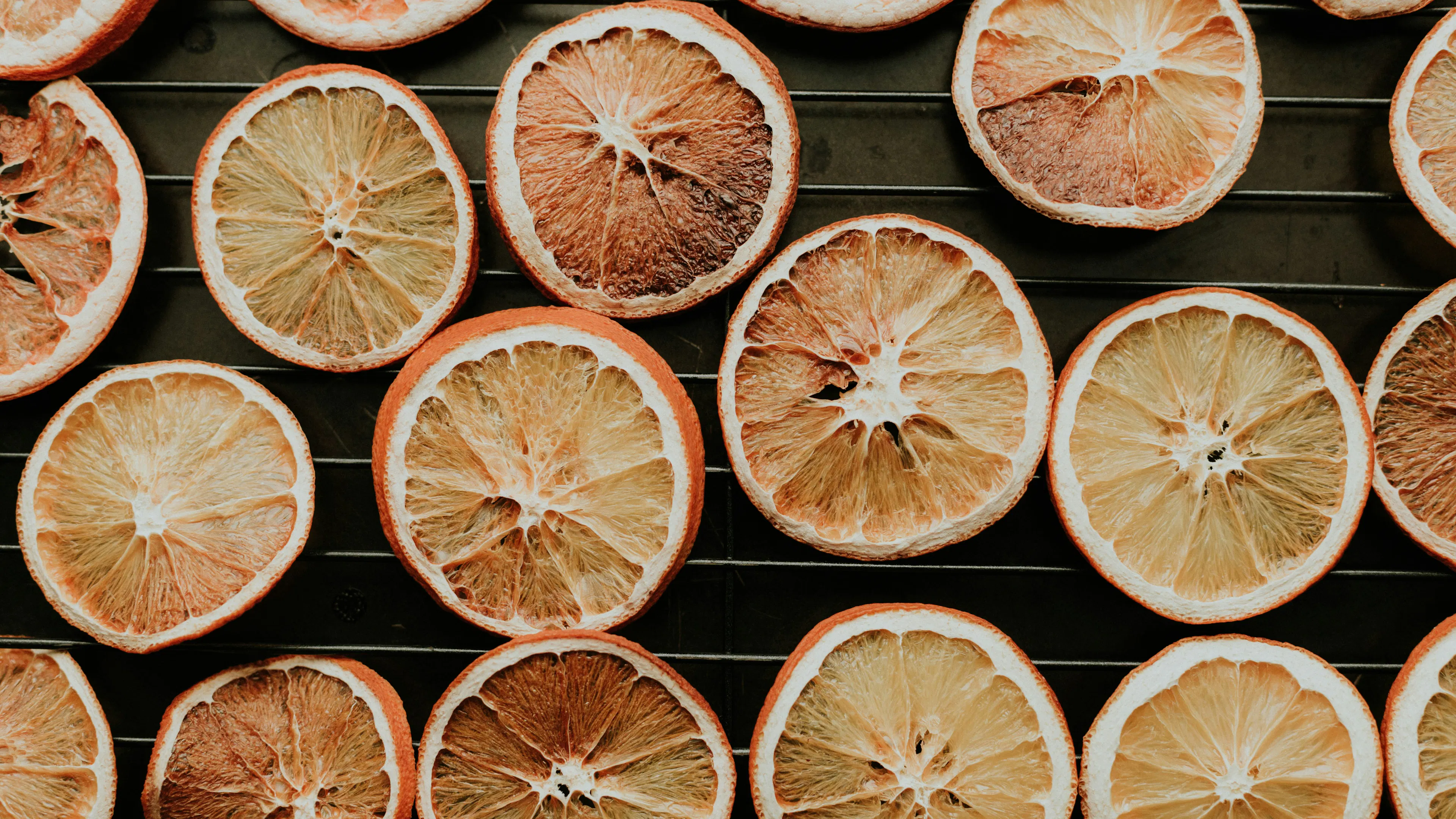 A baking tray covered with slices of dried oranges
