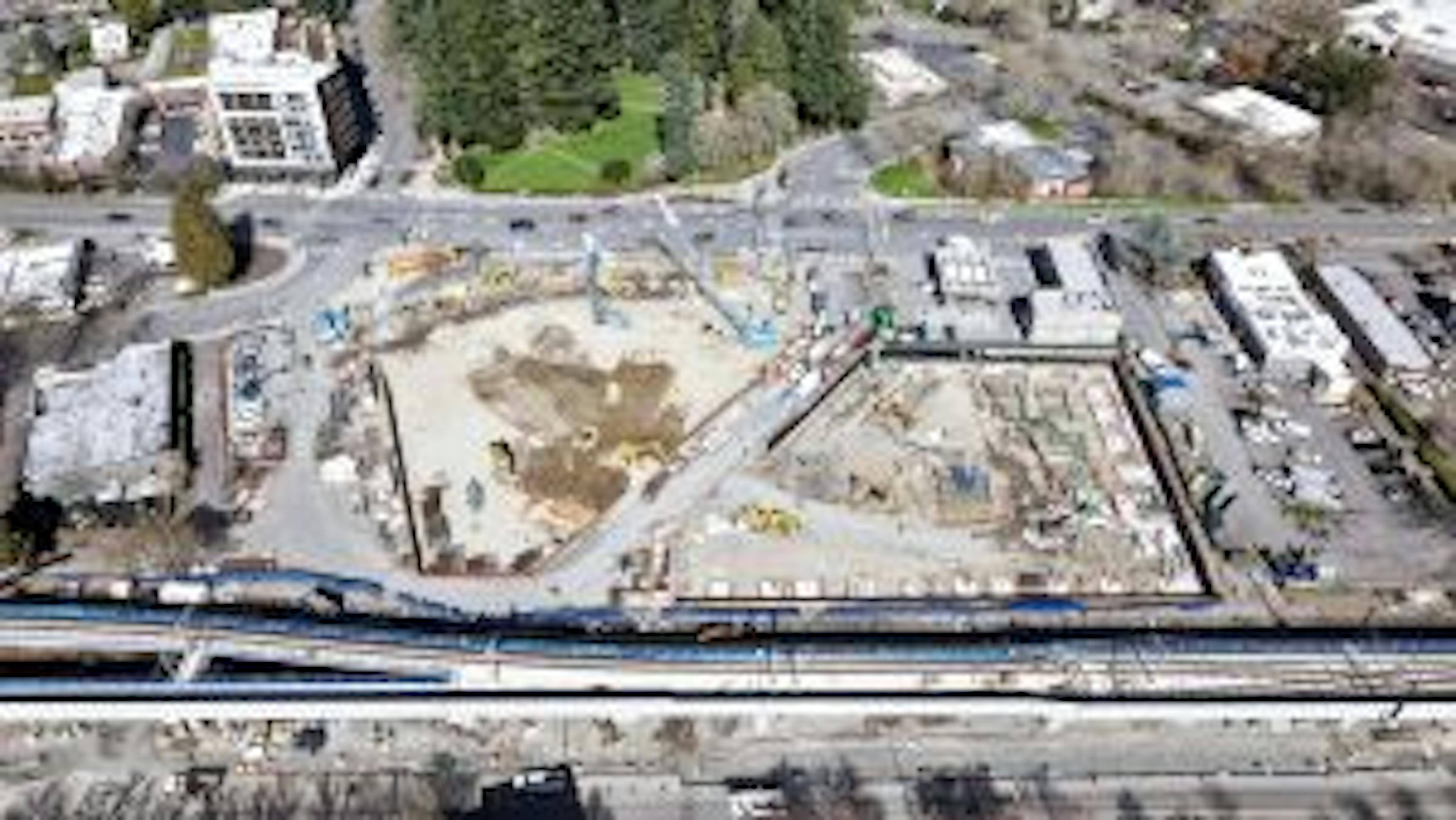 Aerial view of AMLI Redmond Way construction site with footings and foundation underway on east building and shoring underway on west building