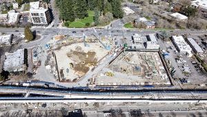 Aerial view of AMLI Redmond Way construction site with footings and foundation underway on east building and shoring underway on west building
