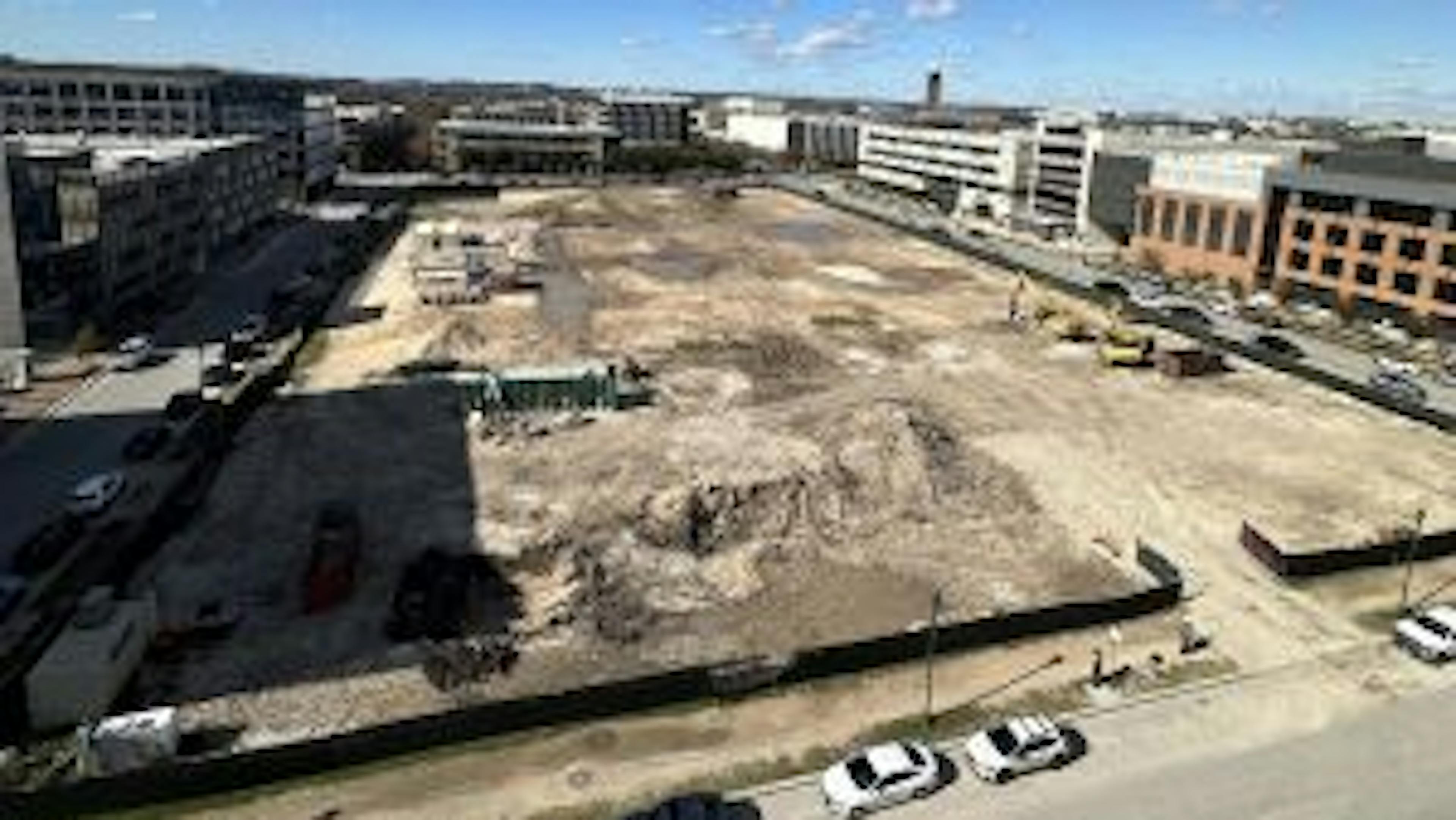 Aerial view of empty AMLI Park Central construction site surrounded by buildings