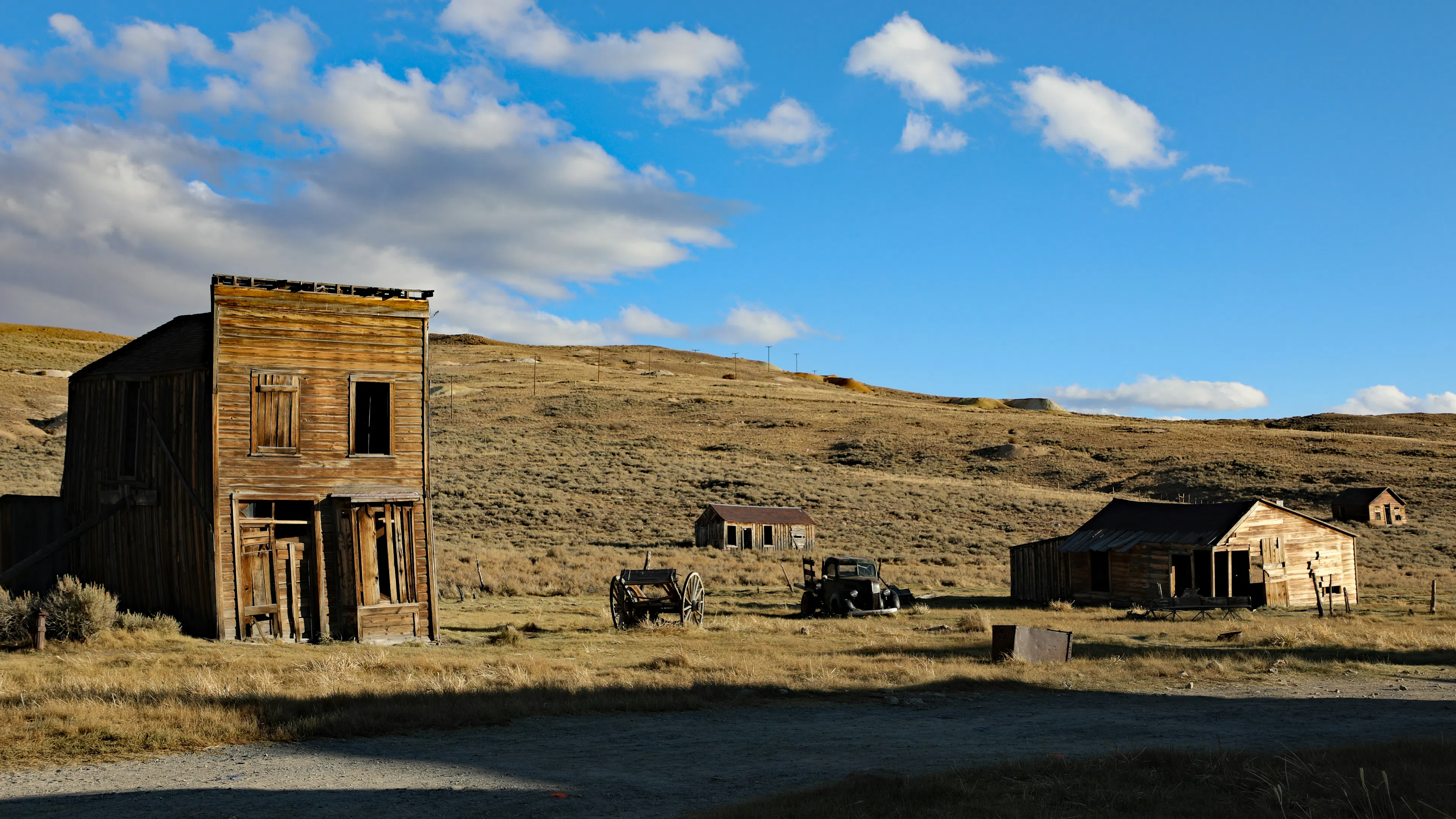 Bare hills with a few mining shacks built into the ground