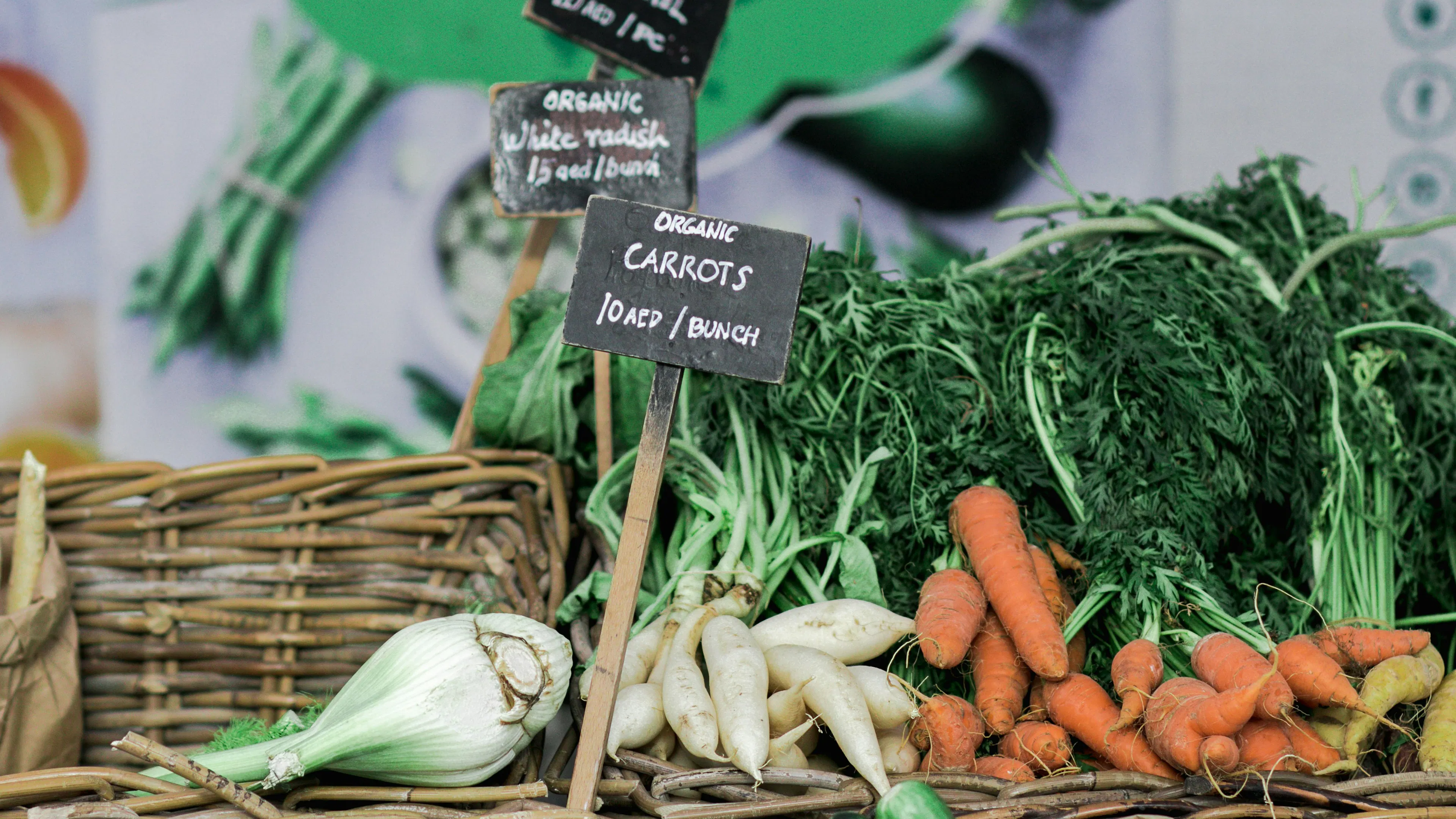 Wicker baskets full of vegetables on a farmers market table