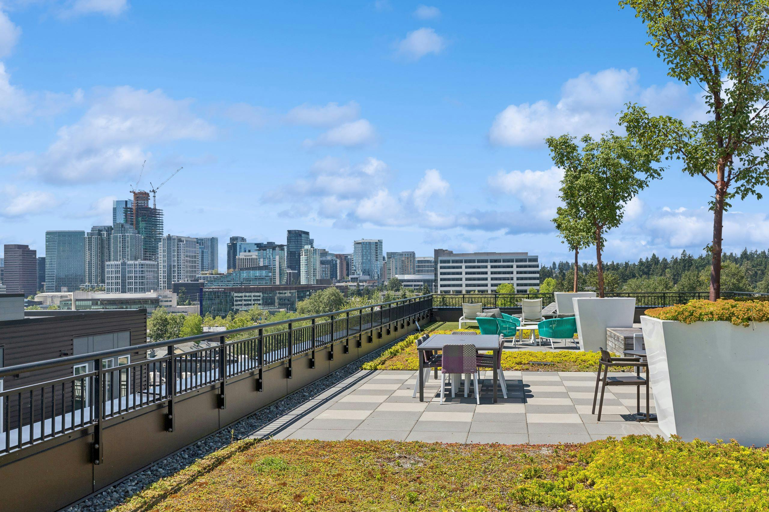 Downtown Bellevue view from the rooftop of AMLI Spring District apartments with ground cover and seating areas