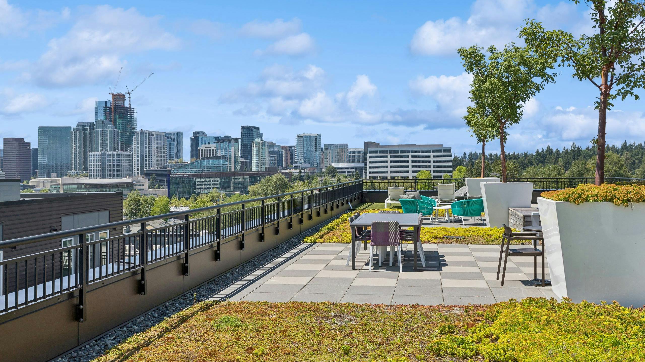 Downtown Bellevue view from the rooftop of AMLI Spring District apartments with ground cover and seating areas