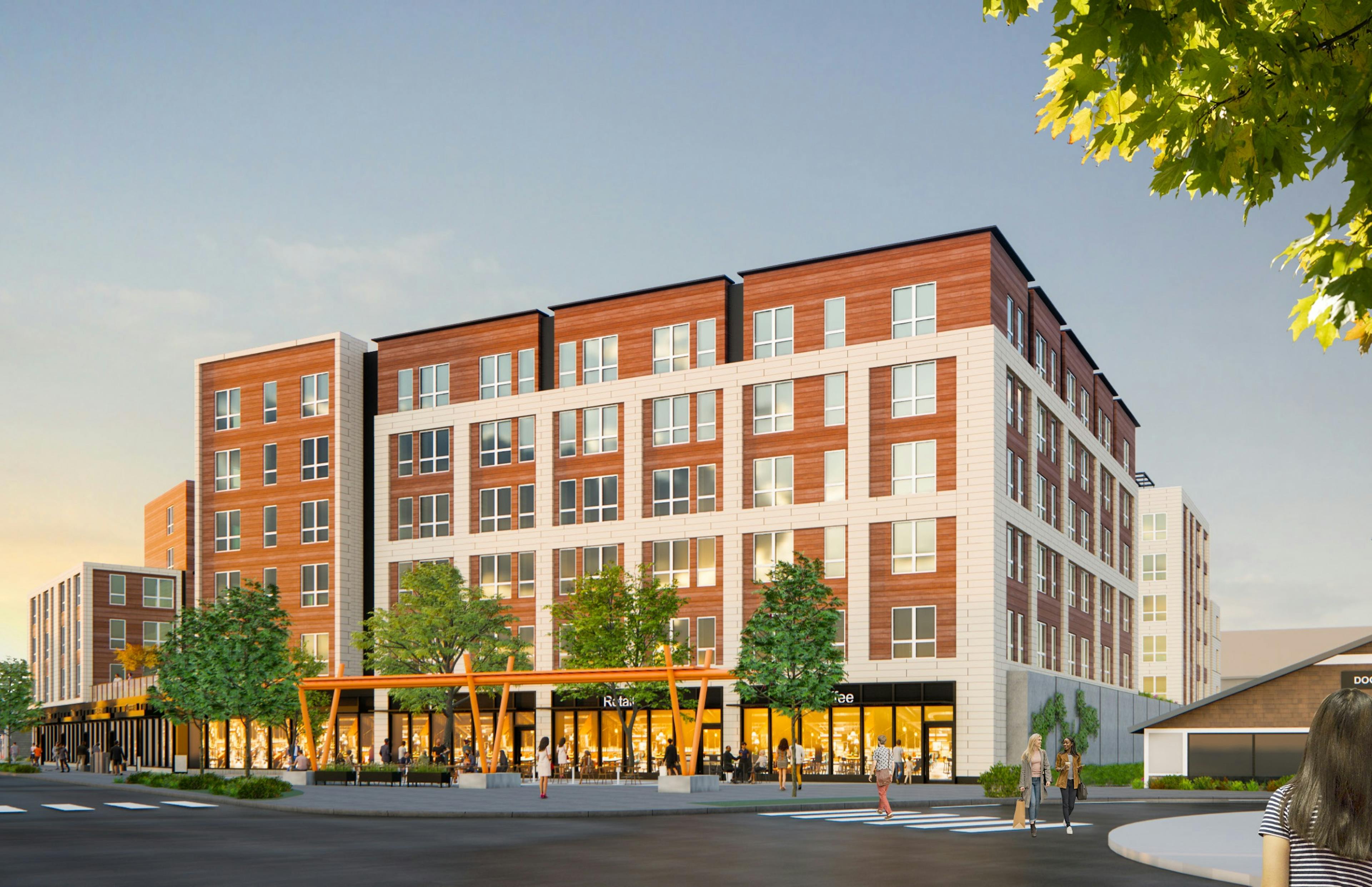 Corner view of AMLI Redmond Way apartment building with brick facade trees wide sidewalk and people walking under blue sky