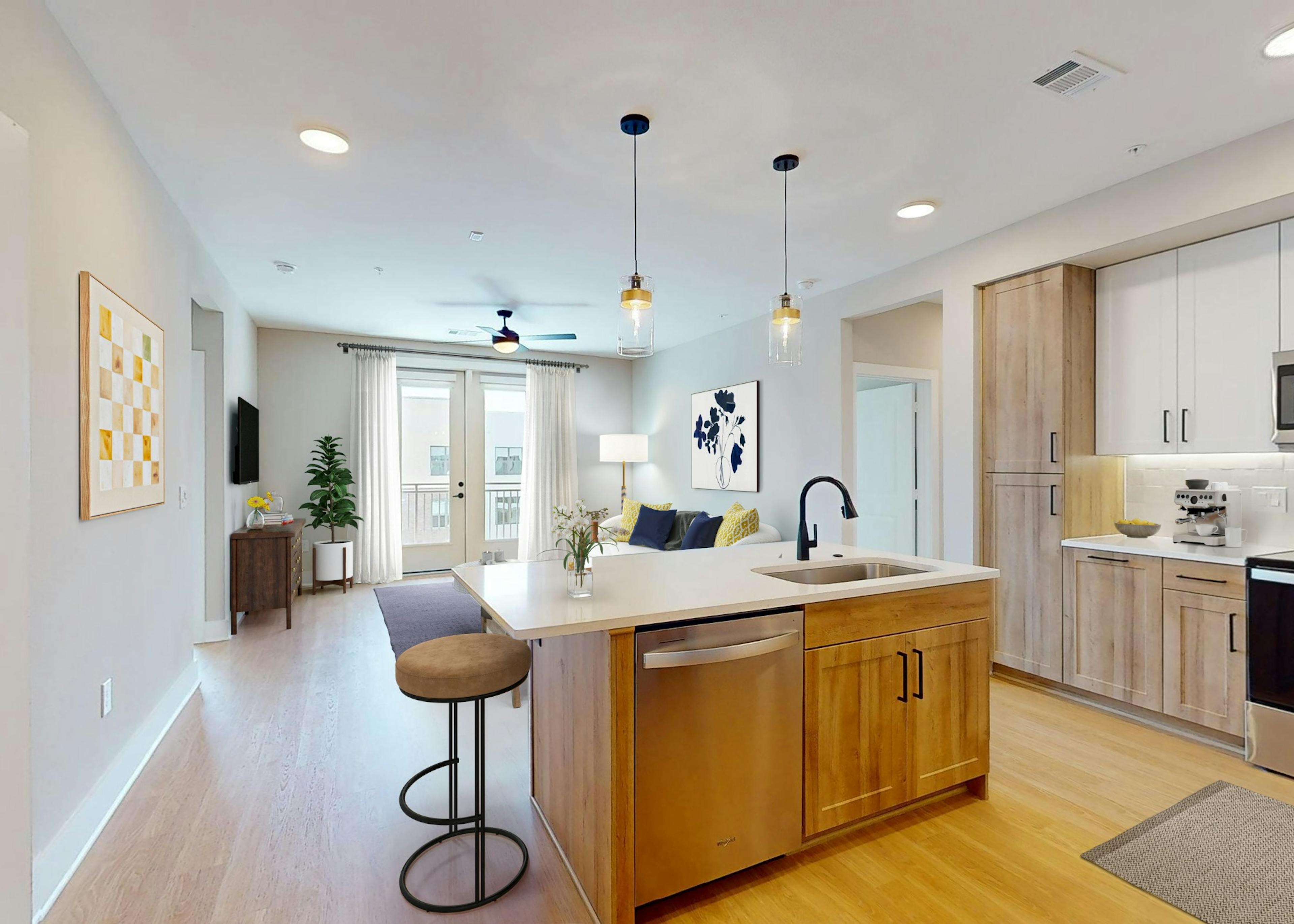 Kitchen at AMLI North Park apartments featuring a stainless steel dishwasher and oven nestled between wooden cabinets and quartz countertops