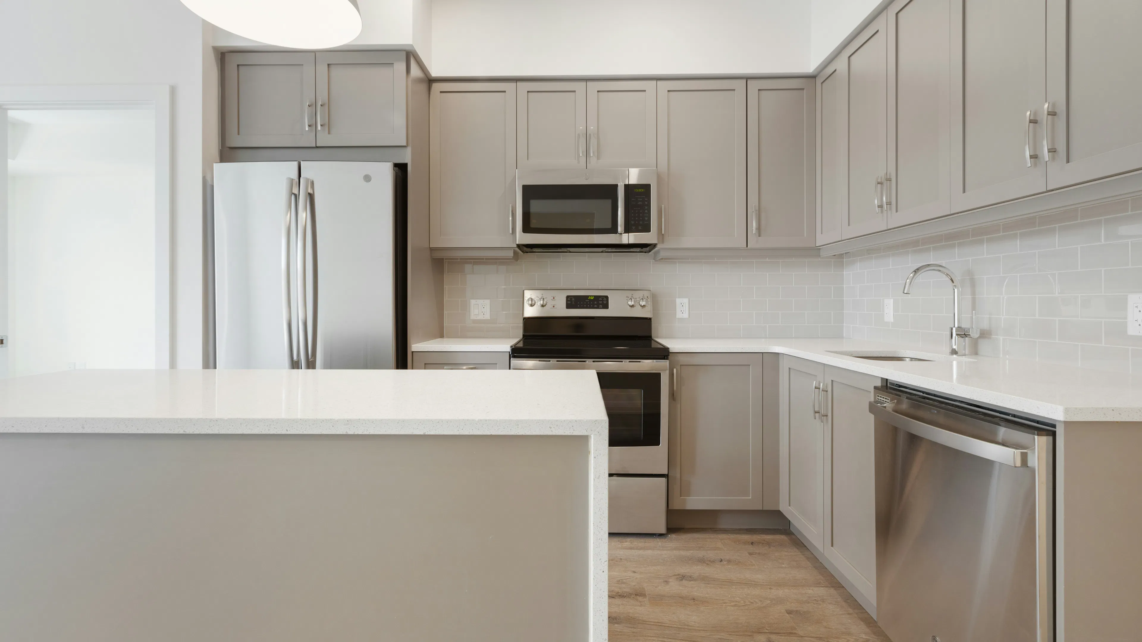A modern clean kitchen with stainless steel appliances