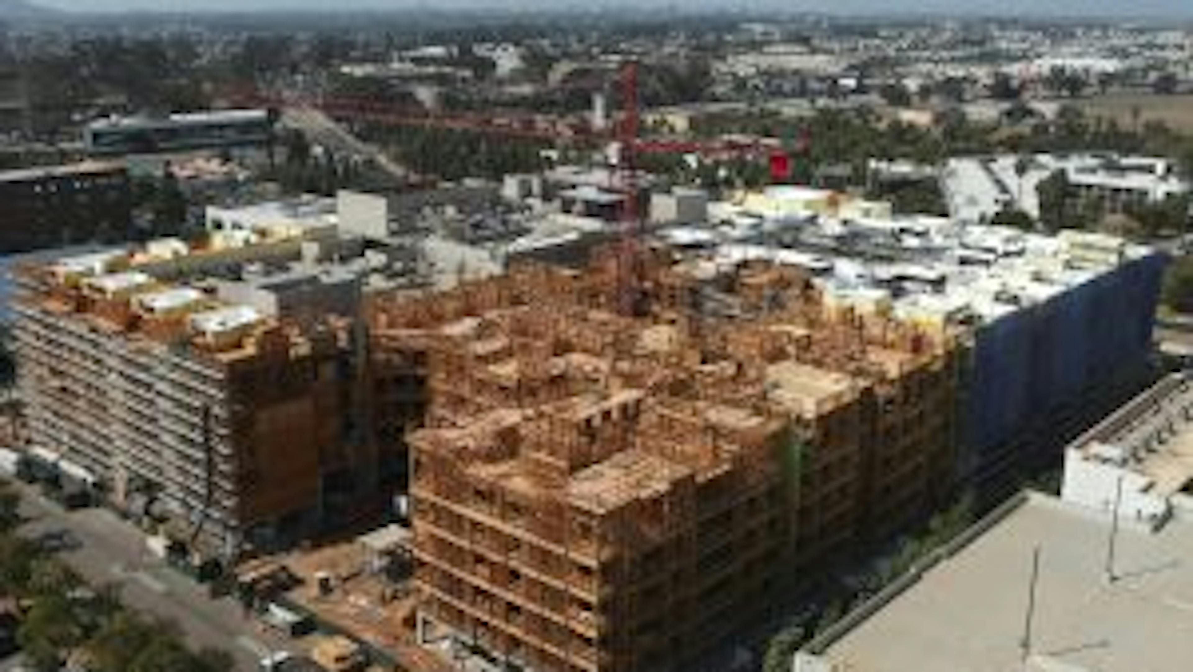 Aerial view of AMLI Aero apartments under construction with wood framing and many stories underway
