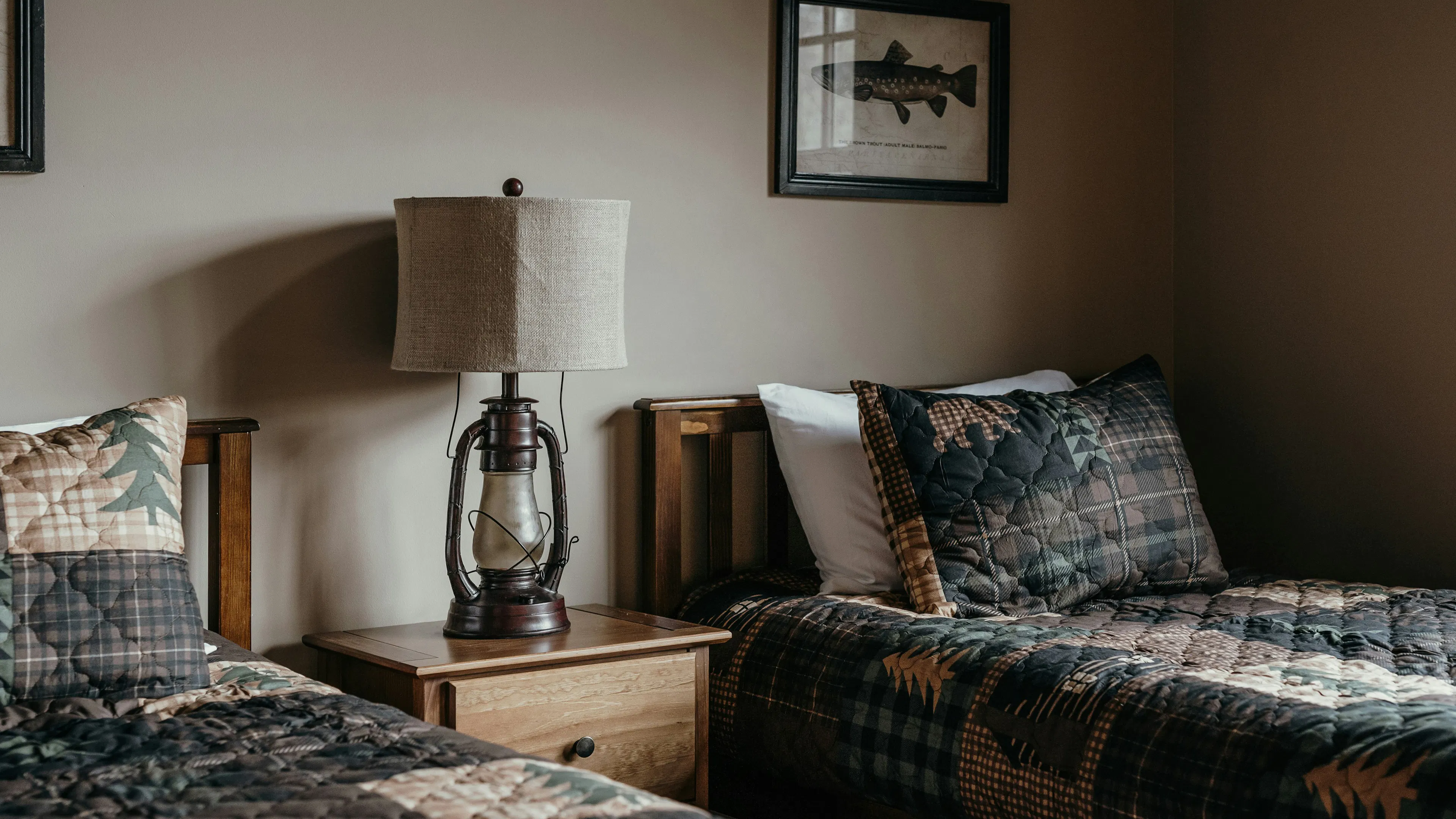 Two twin beds fitted with cabin style bedding and cabin style furniture 