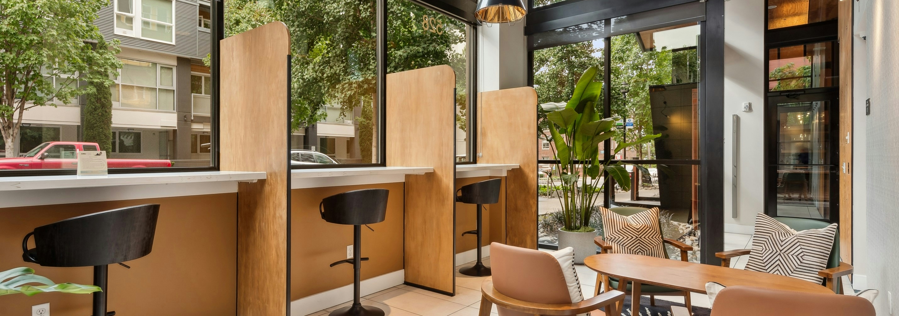 AMLI South Lake Union apartments residential coworking space with extra tall ceilings and windows that face the ground level of the street.