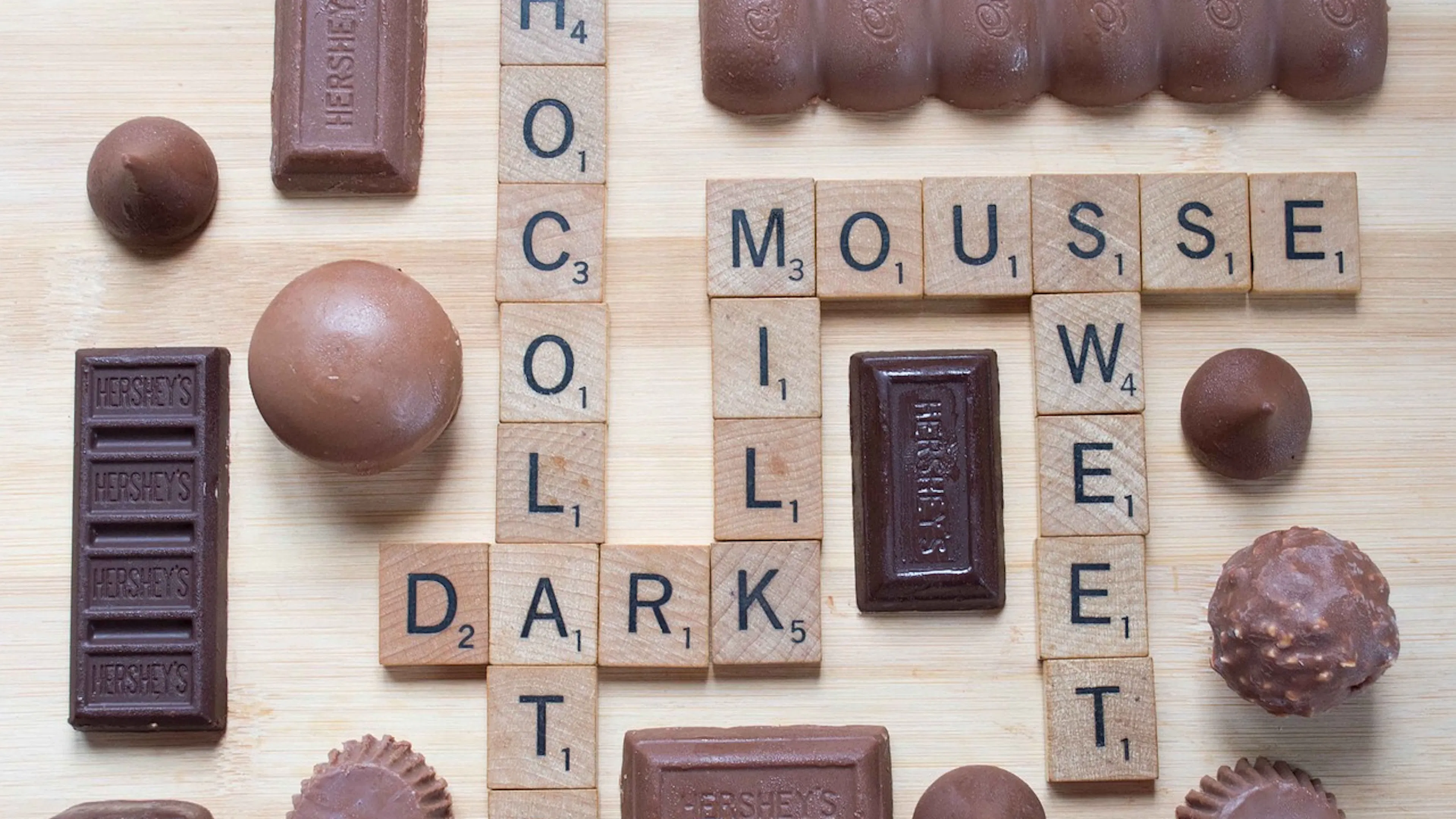 light and dark chocolates surrounding a scrabble board with chocolate themed names