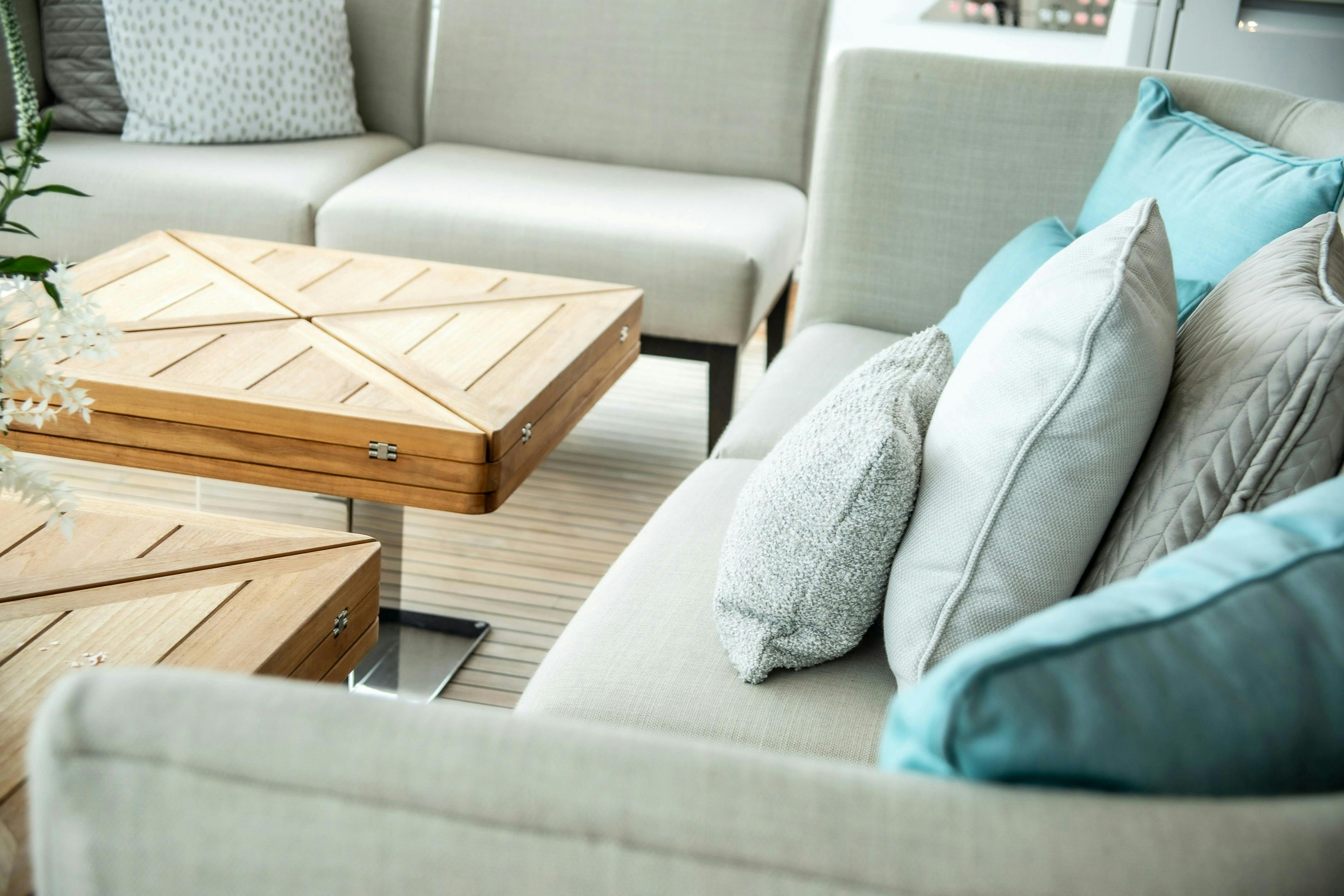 A living room filled with furniture and decorated with light blue couch cushions