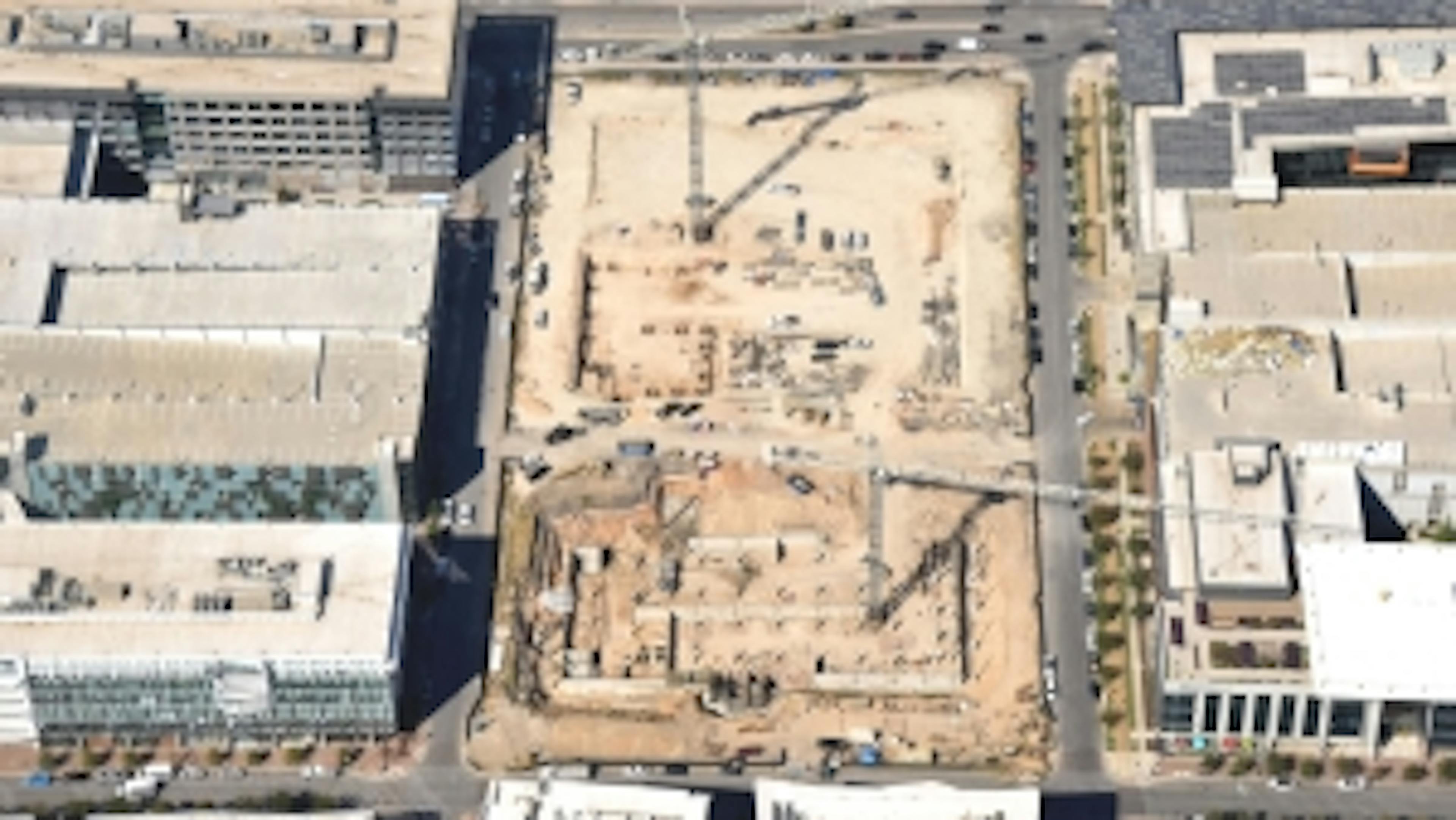 Aerial view of AMLI Park Central construction site with cranes and trucks and the east garage retaining walls being poured