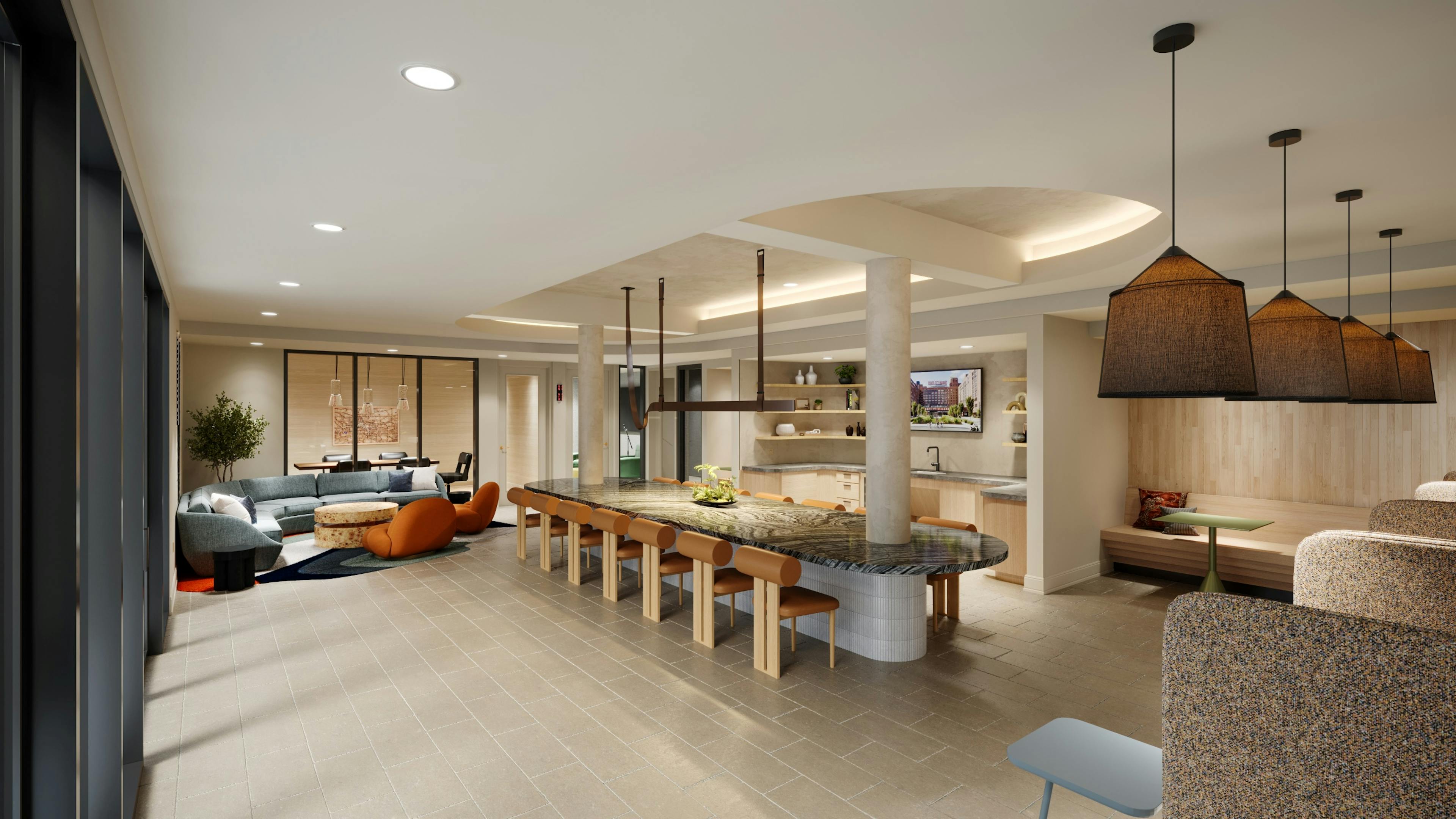 Resident lounge with large marble island at AMLI Old 4th Ward with various seating areas on tile floors and a kitchen.