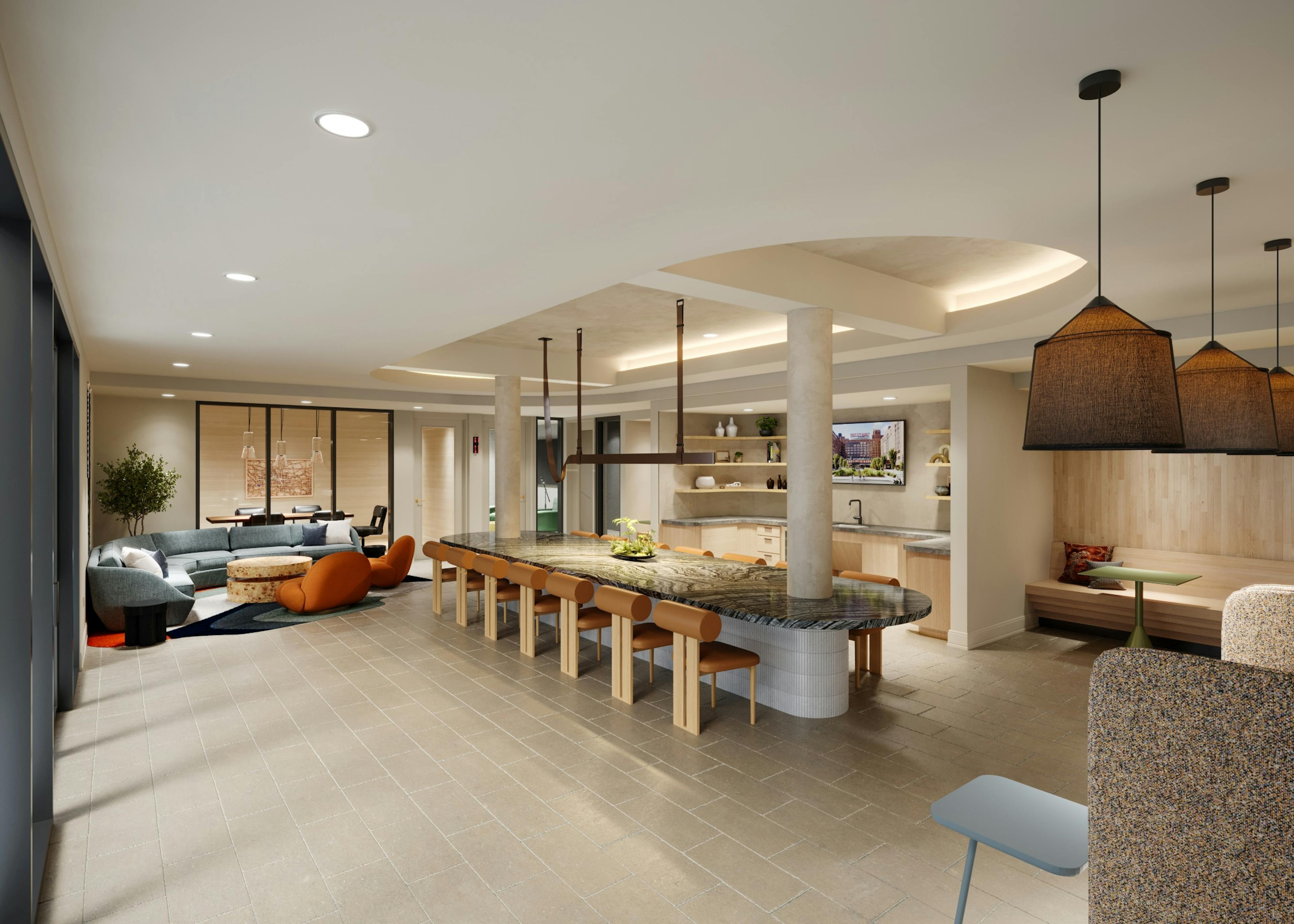 Resident lounge with large marble island at AMLI Old 4th Ward with various seating areas on tile floors and a kitchen.