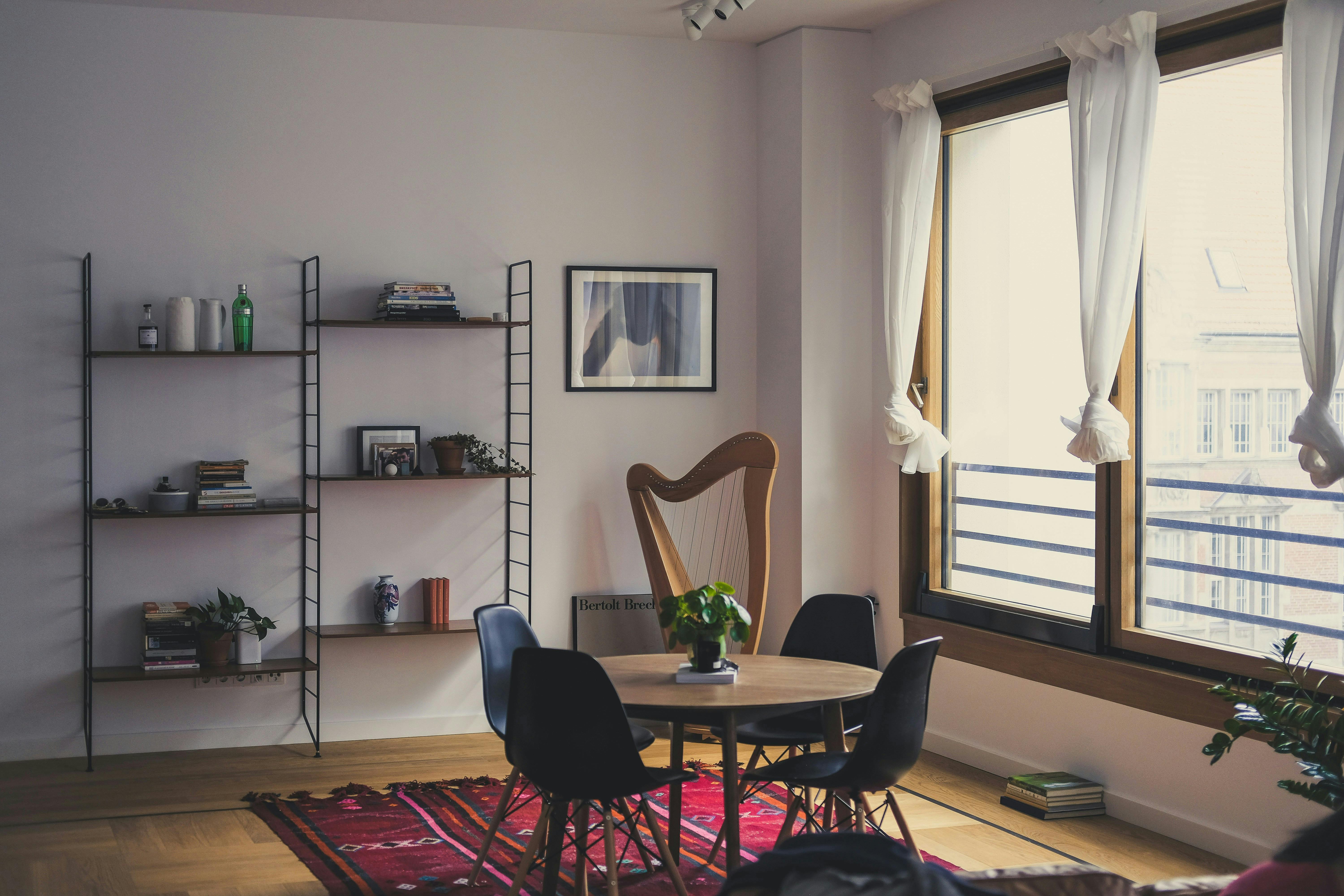 A harp placed in the corner of a bright and airy apartment