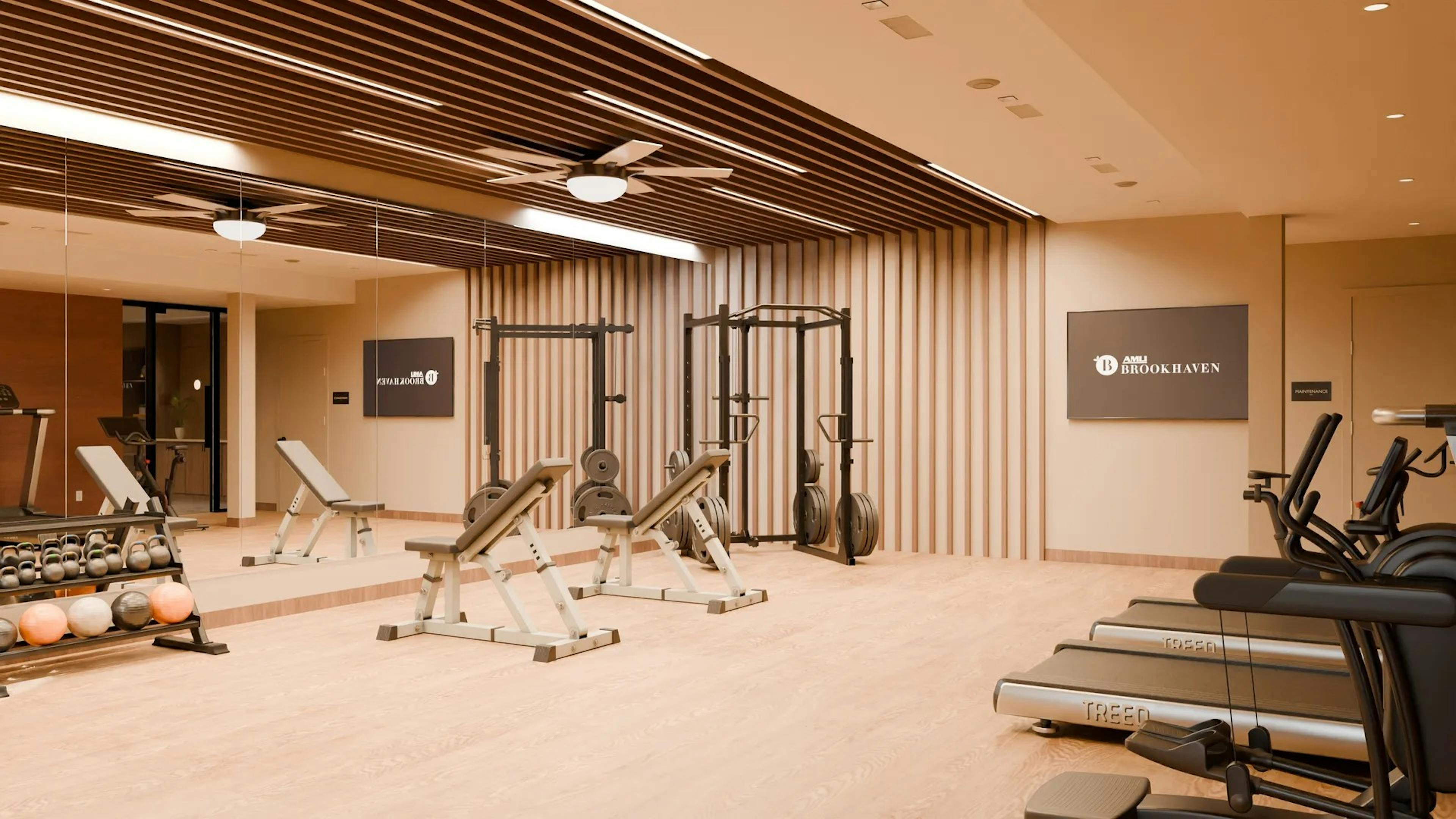 Rendering for AMLI Brookhaven fitness center with various weights and machines set on a wood floor against a mirrored wall