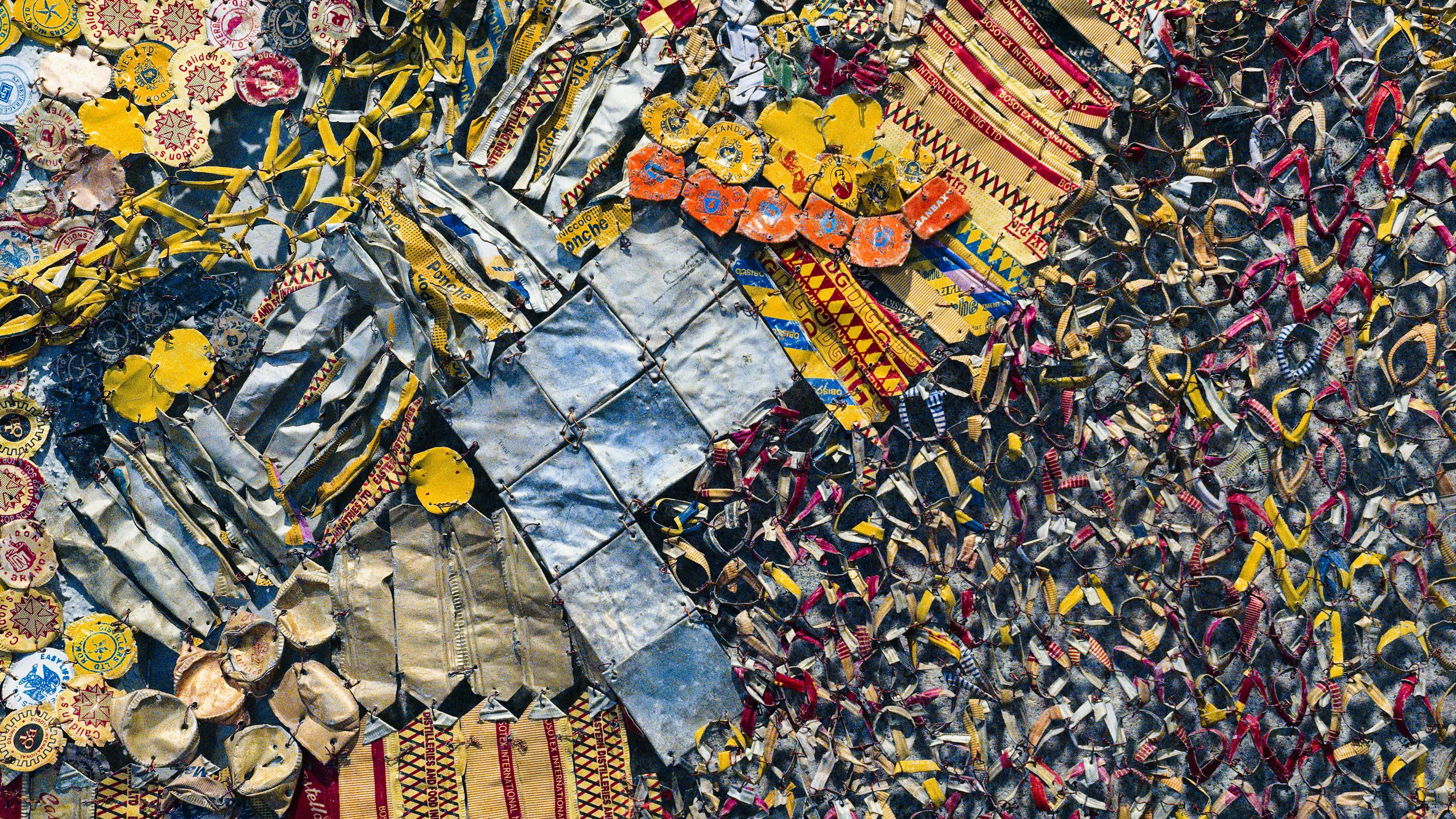 Some scrap aluminum pieces arranged in a colorful pattern of yellows and blues