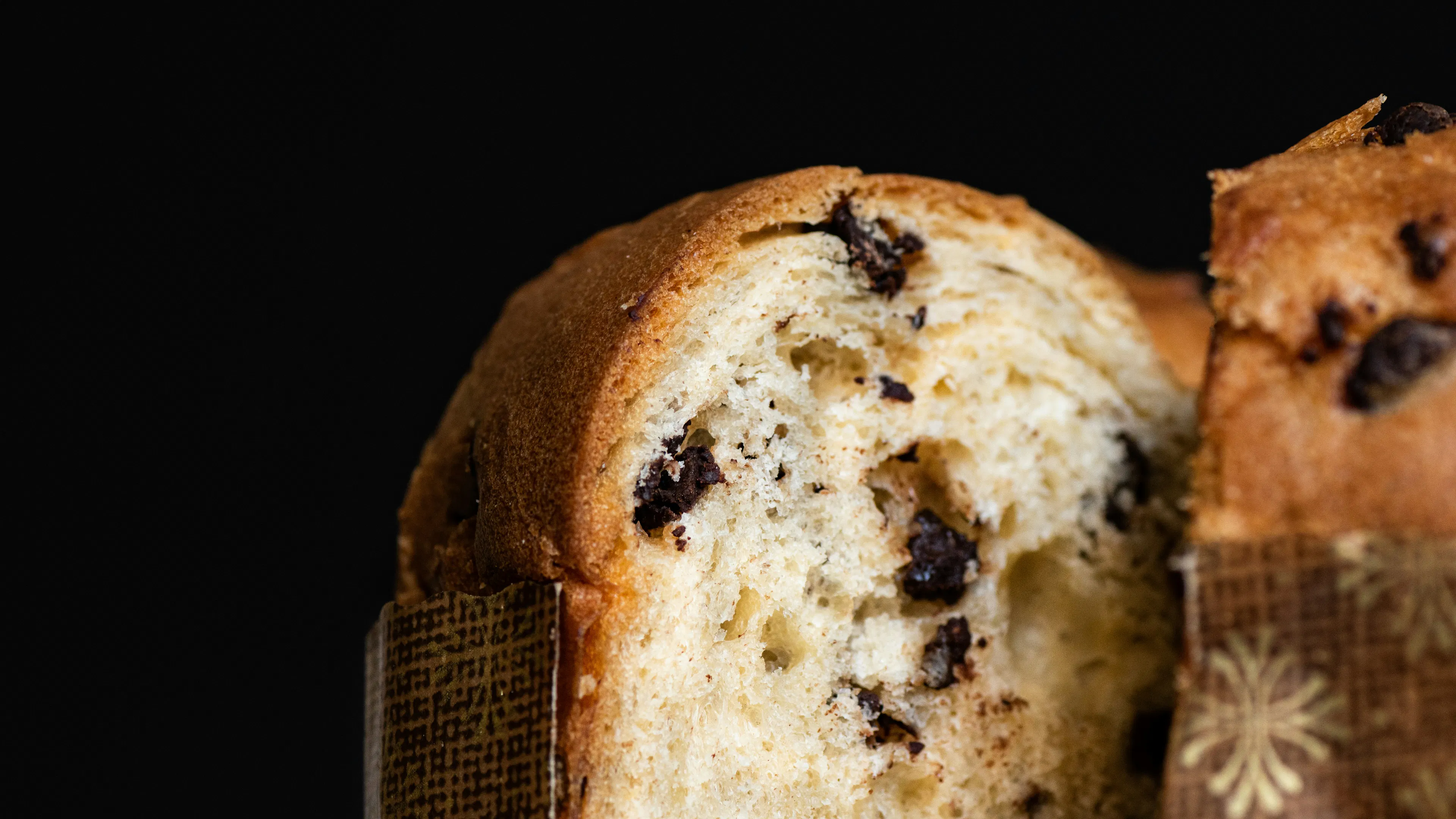 A close up of a chocolate panettone bread sliced in half